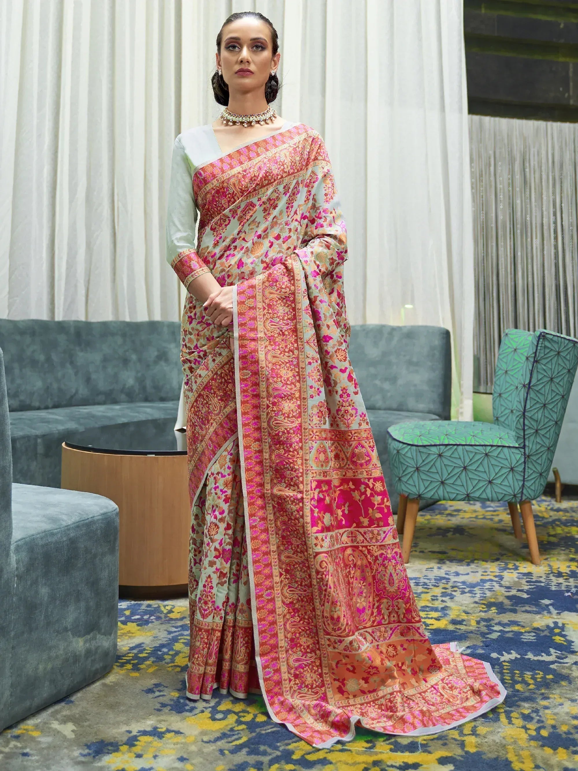 Woman in elegant floral paisley saree with light blue blouse, perfect for Indian ethnic occasions
