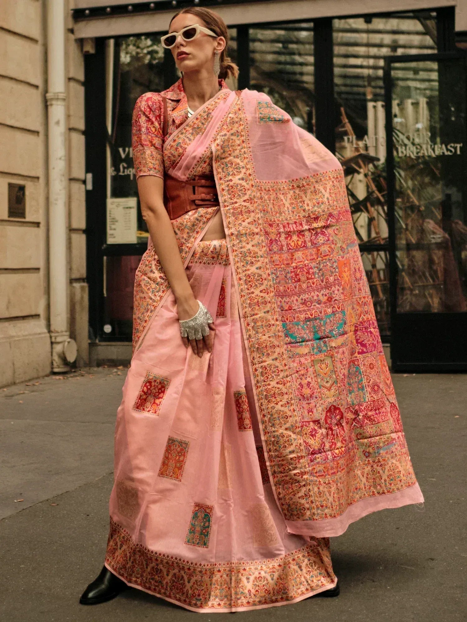 Pink printed saree with patchwork design, styled with belt and sunglasses for modern ethnic look