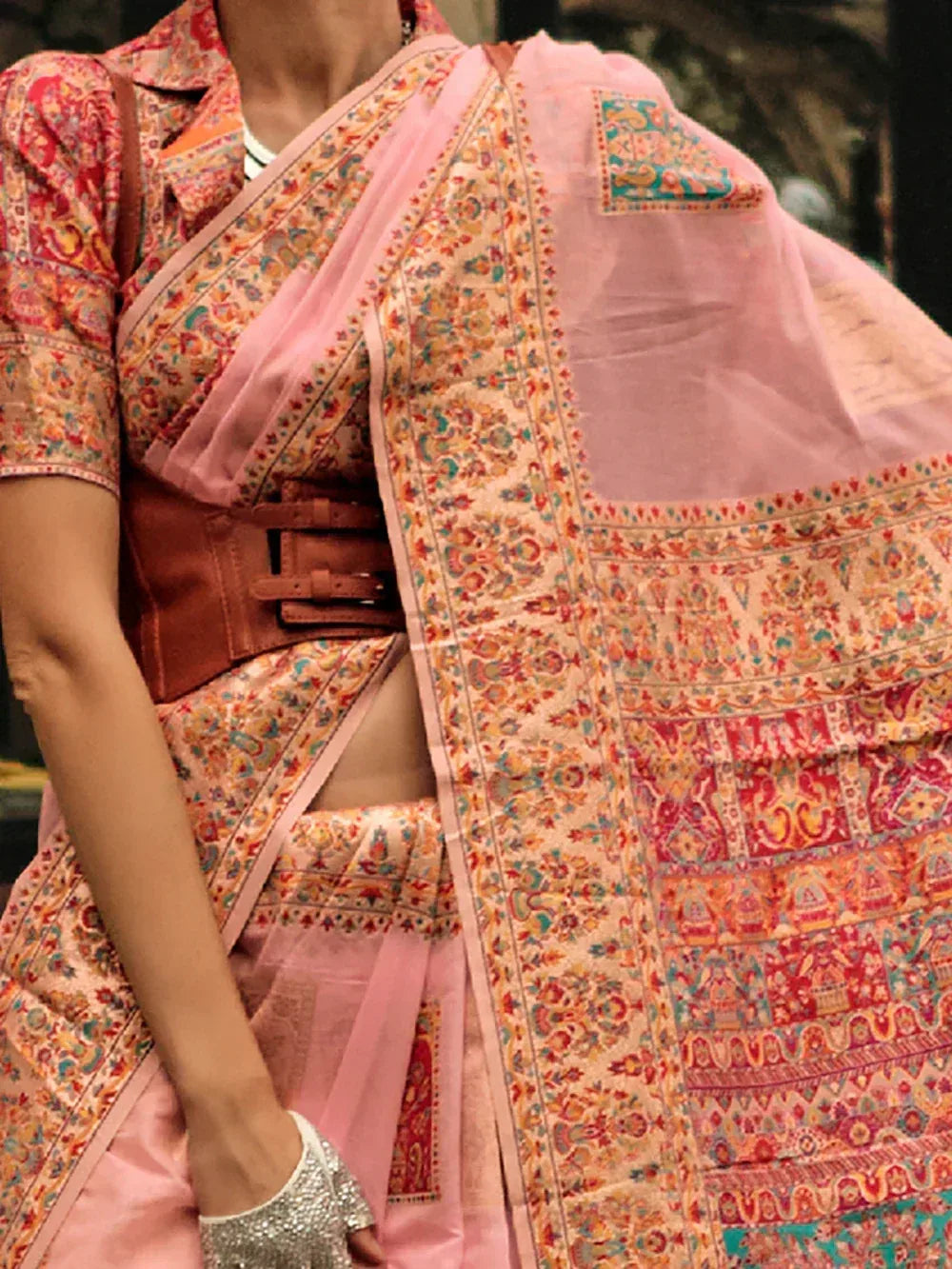Pink printed saree with floral motifs, paired with short sleeve blouse and brown belt, ethnic Indian wear
