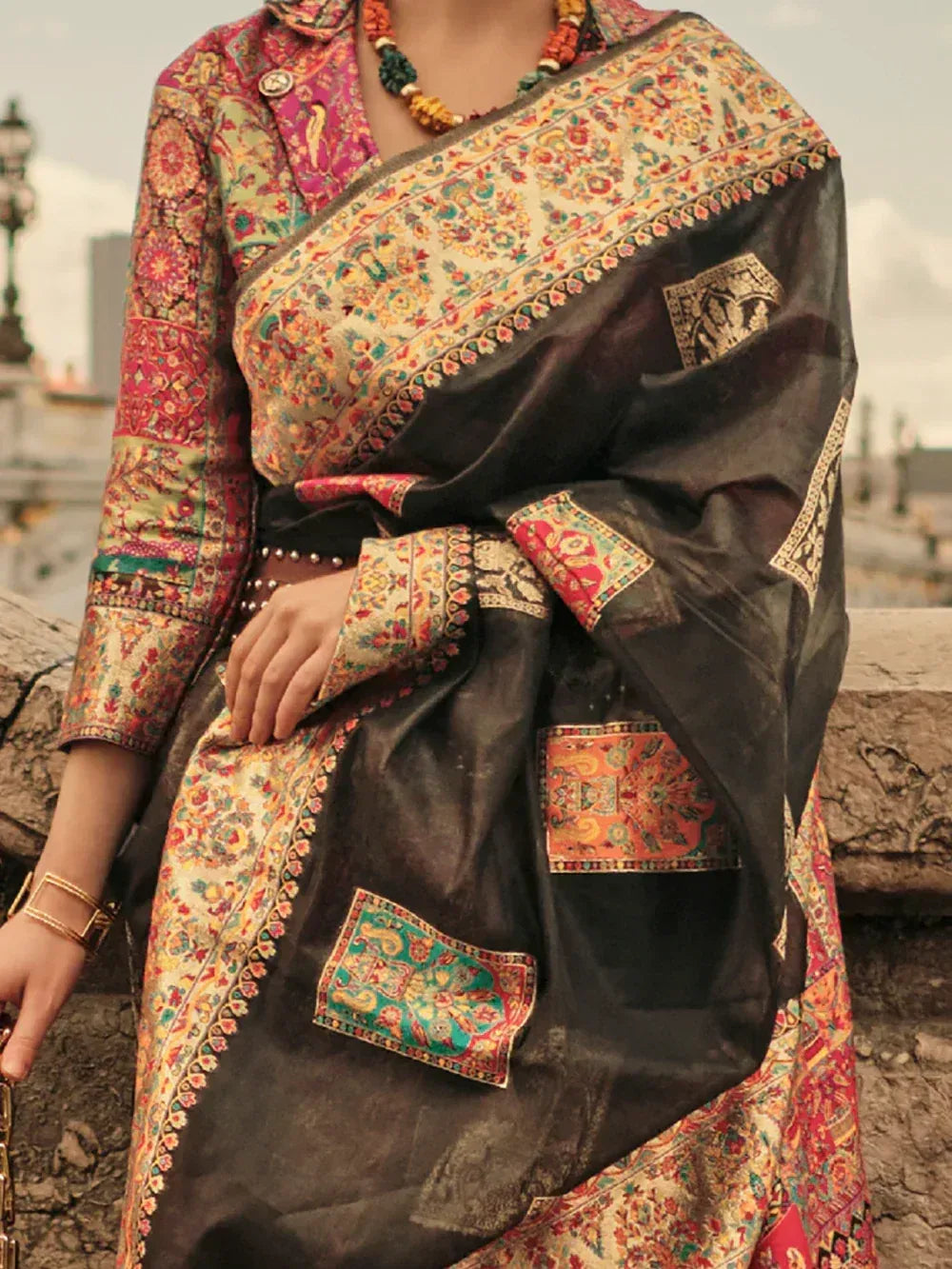 Black floral saree with embroidered patches, paired with matching printed blouse, ethnic Indian wear