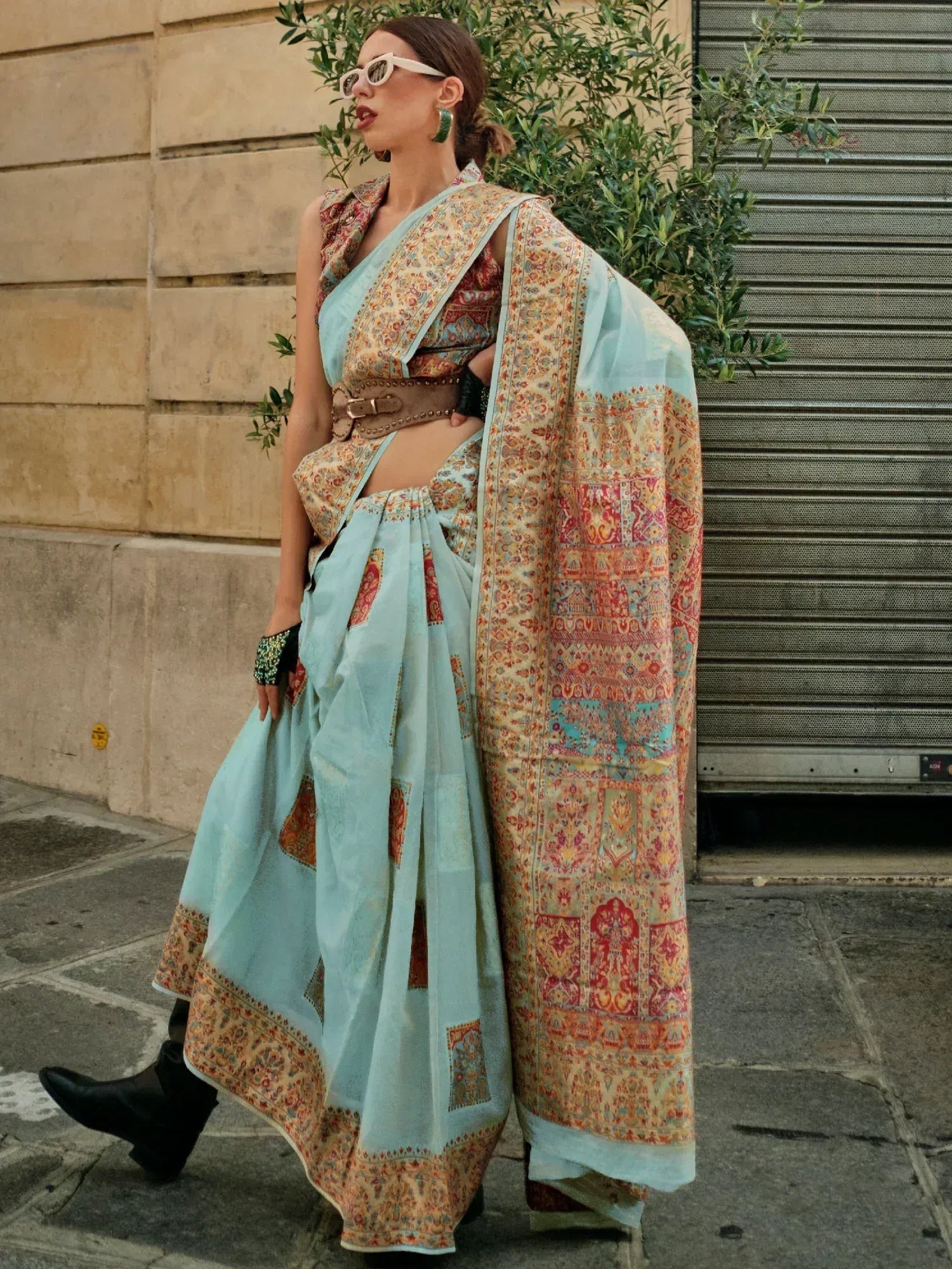 Stylish woman in light blue printed saree with belt, modern ethnic wear for women