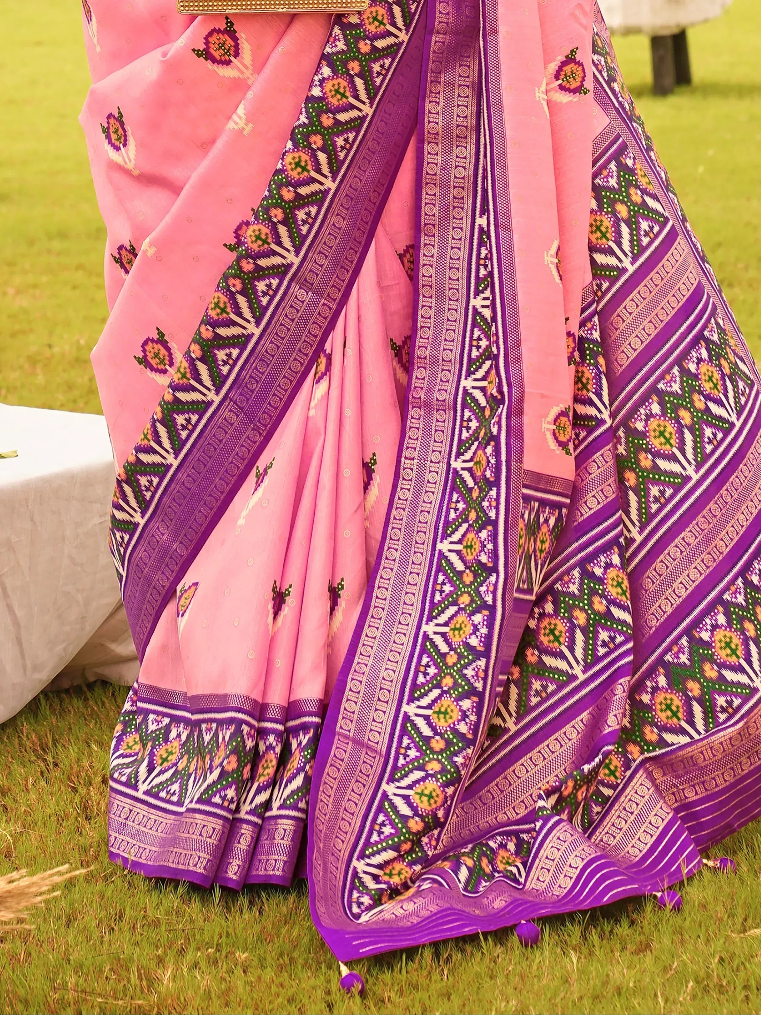 Pink and purple ethnic saree with floral ikat border, perfect for Indian occasions