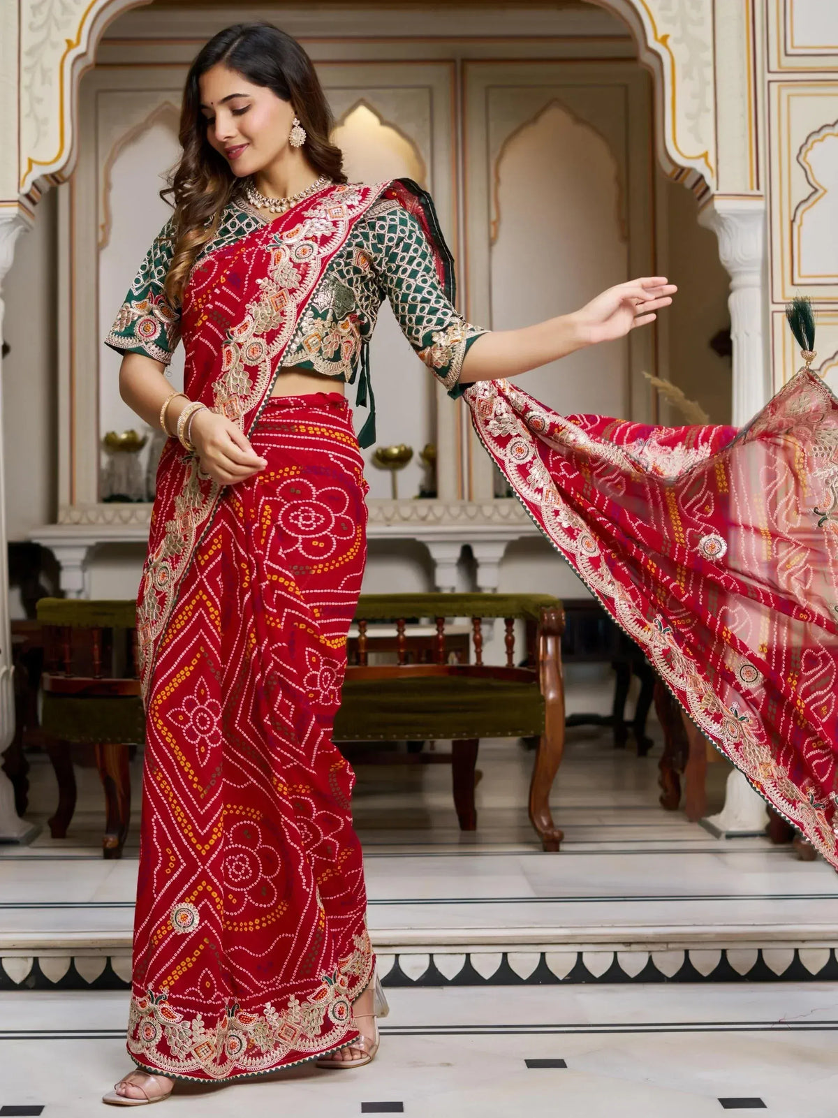 Red and green embroidered ethnic saree with designer blouse, perfect for Indian weddings and festive occasions.