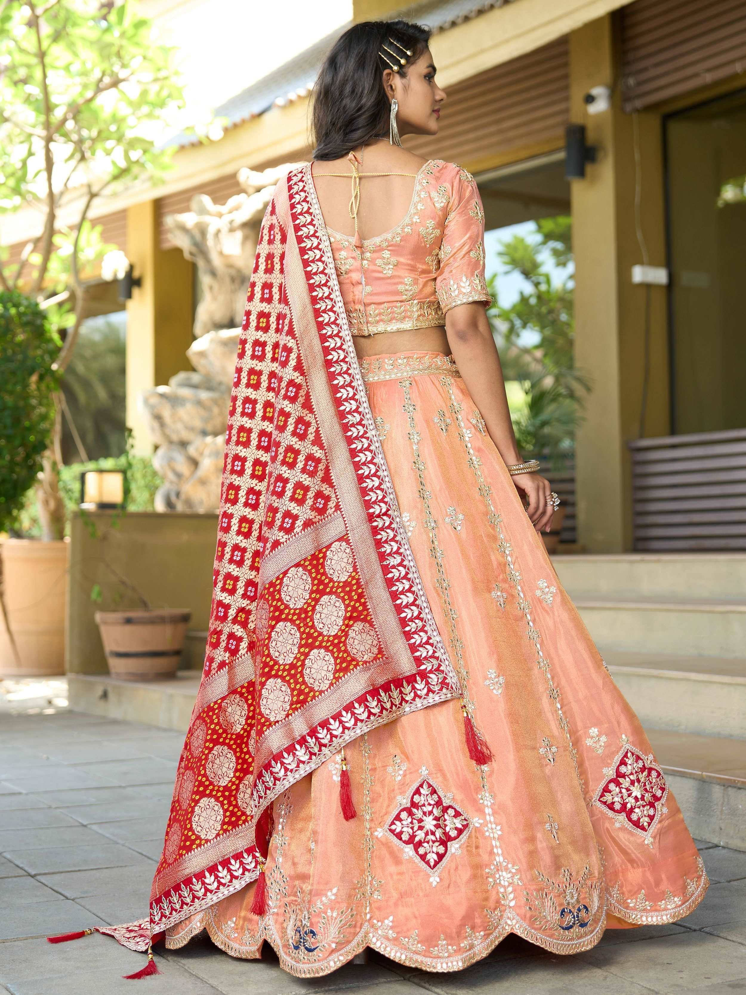 Peach lehenga choli with red dupatta, gold embroidery, perfect for Indian weddings and festive occasions.
