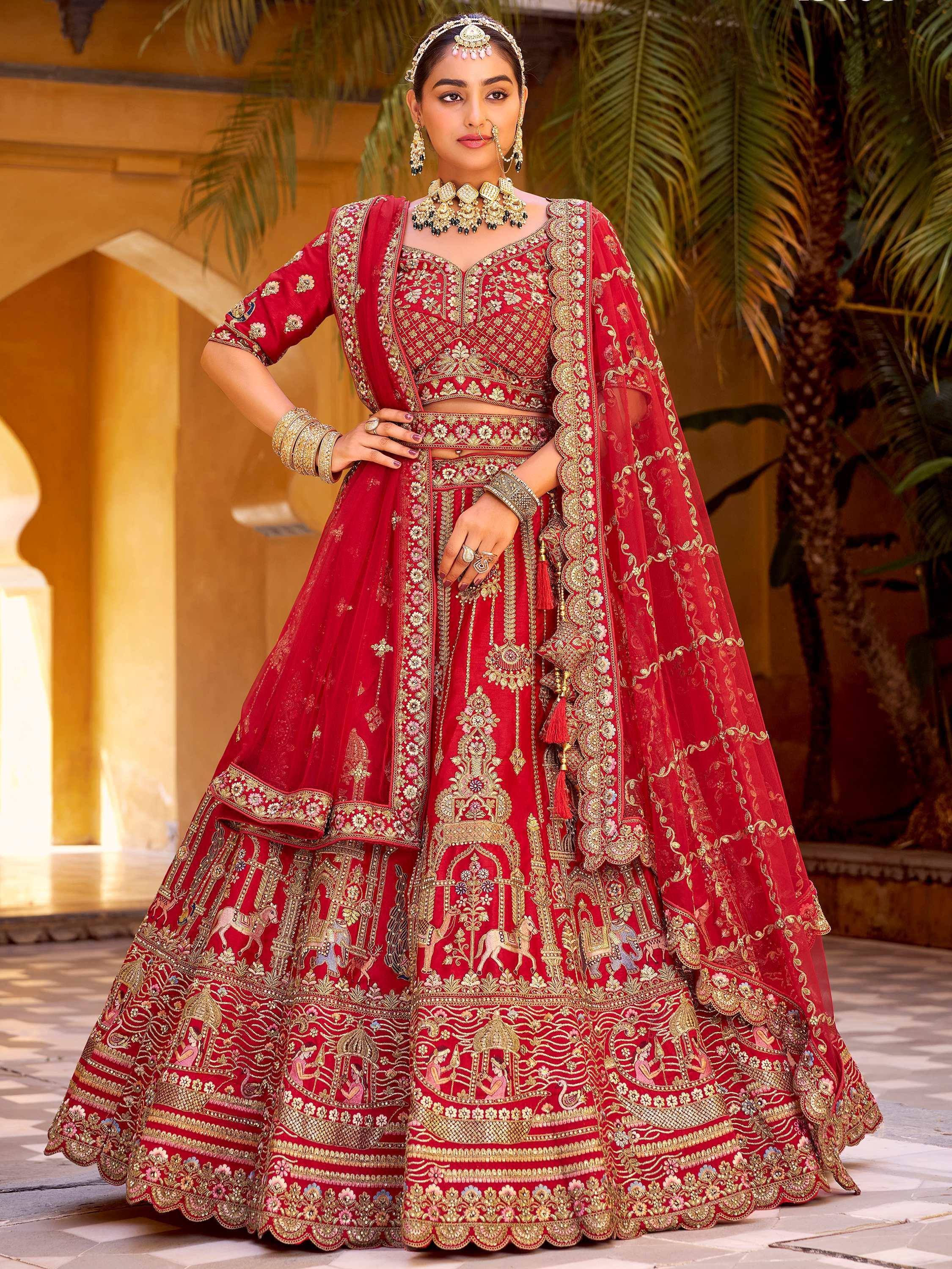 Red embroidered lehenga choli with gold detailing, perfect for Indian weddings and festive occasions.
