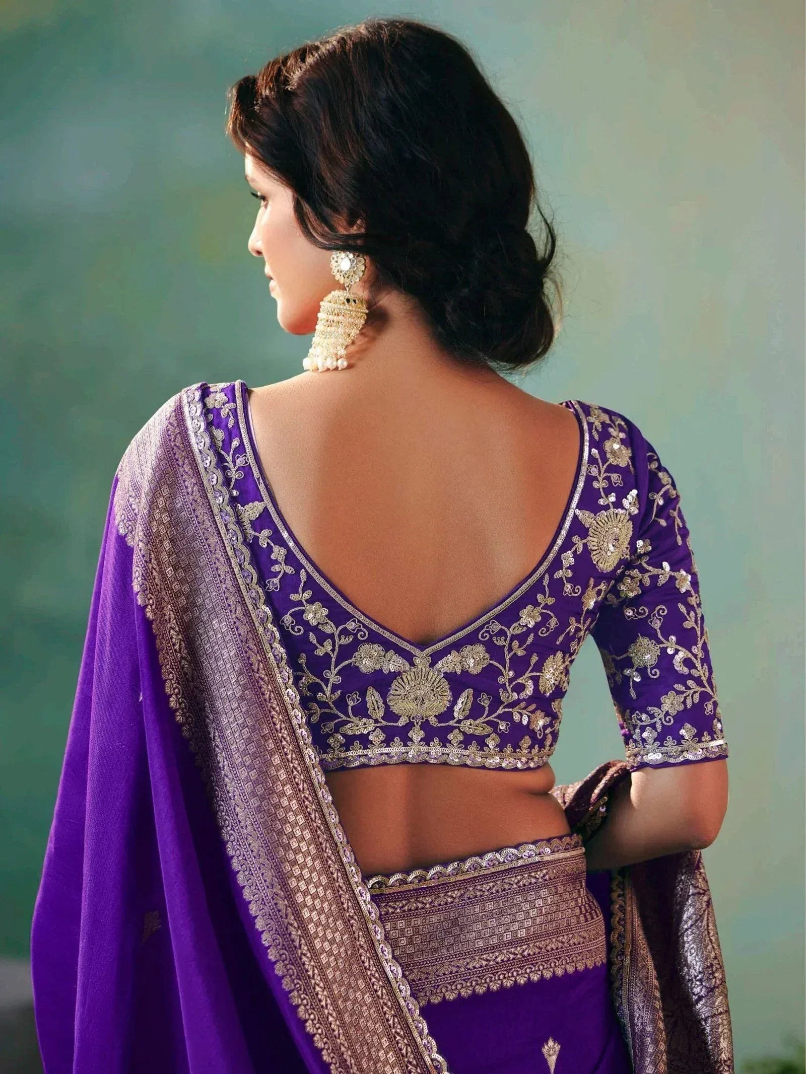Purple embroidered saree with gold detailing and backless blouse design