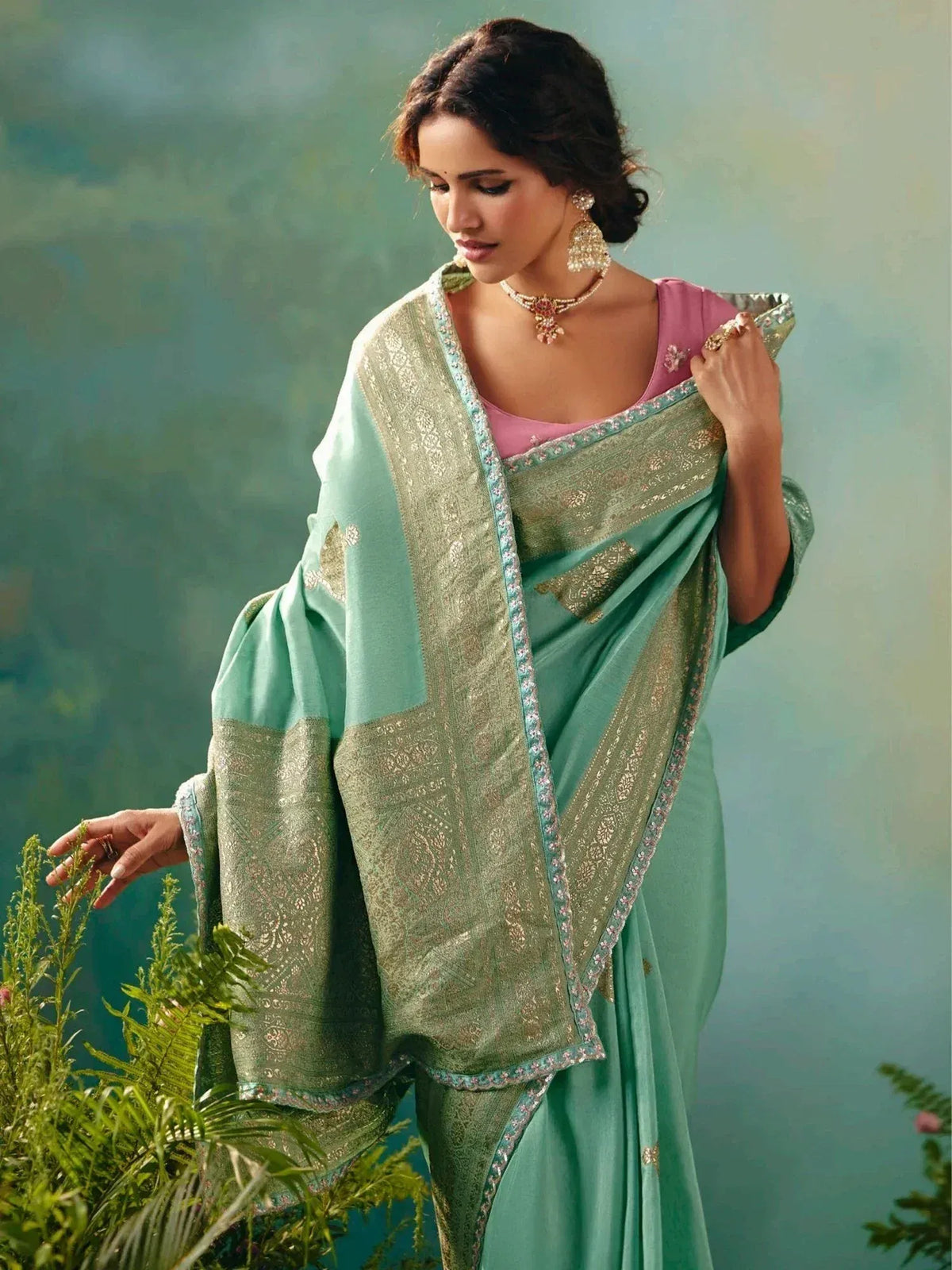 Elegant mint green saree with gold embroidery and pink blouse, styled with traditional jewelry for Indian ethnic wear.