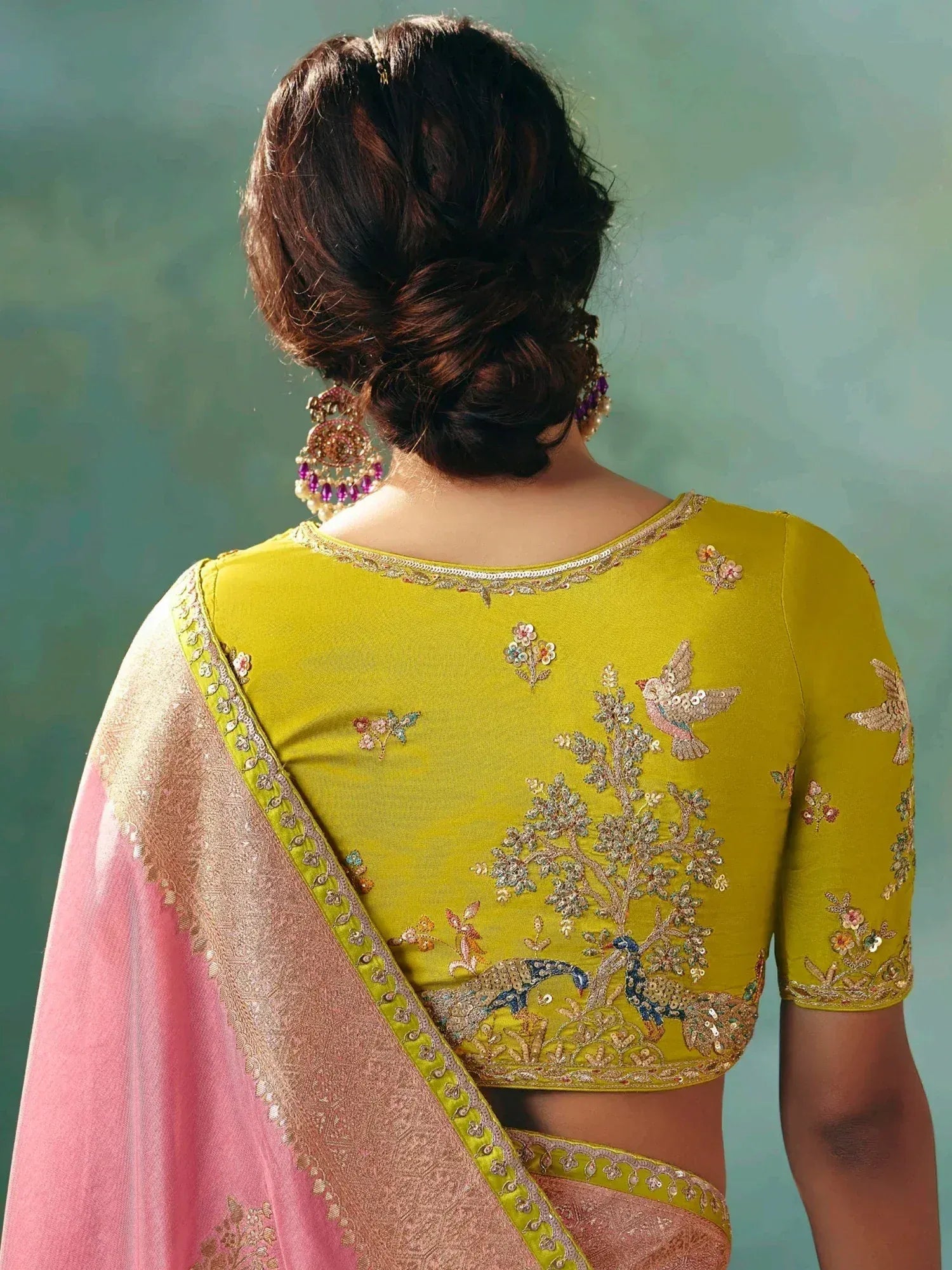 Yellow embroidered blouse with peacock and bird motifs, paired with pink saree, Indian ethnic wear