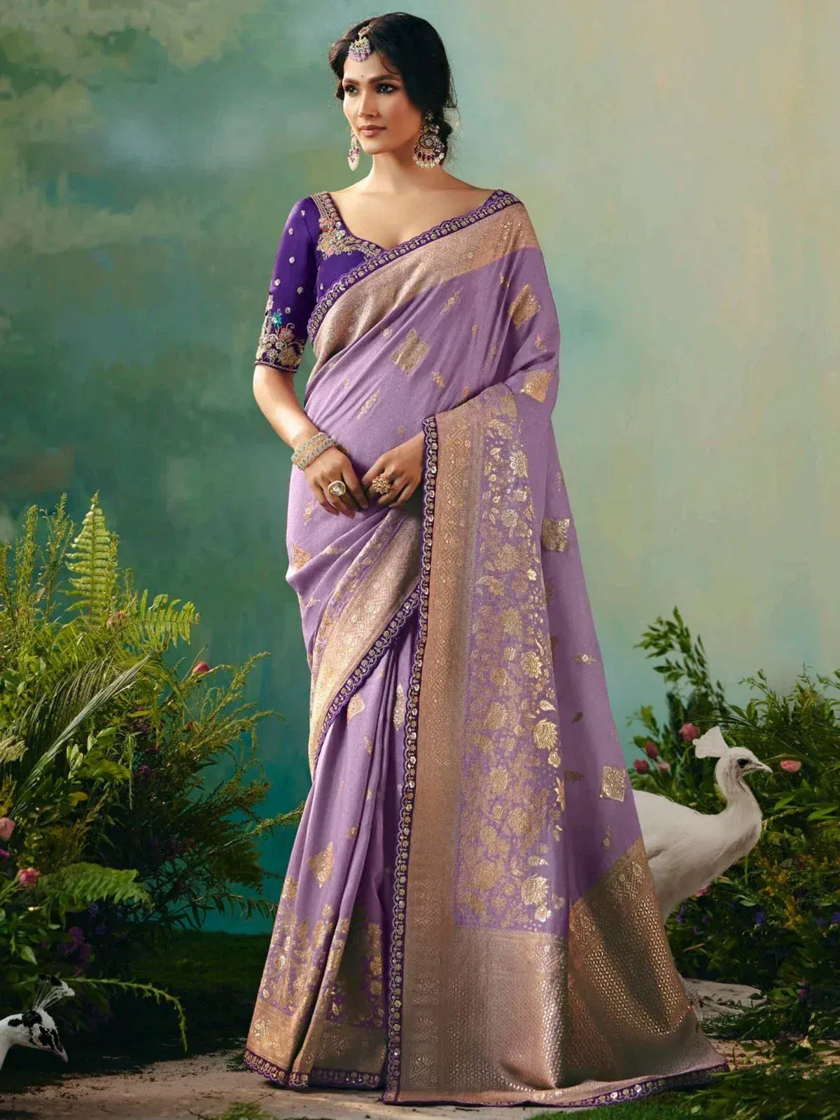 Purple designer saree with gold embroidery and blouse, styled with traditional jewelry for ethnic wear