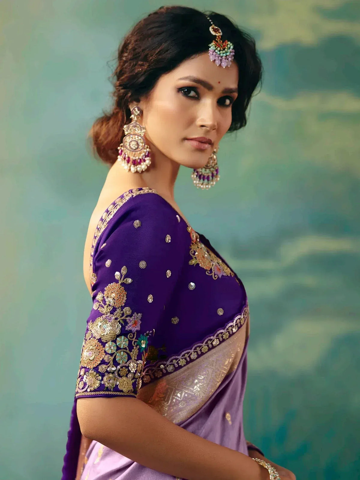 Purple embroidered saree with gold floral work, designer blouse, and traditional Indian jewelry for ethnic wear