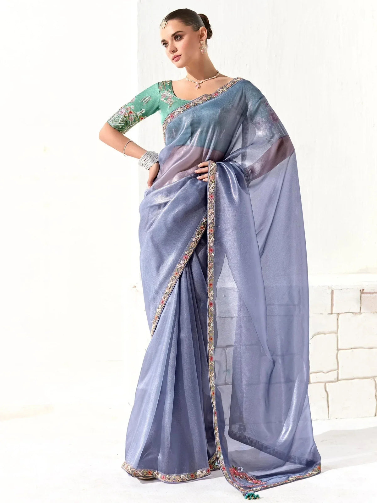 Elegant blue saree with floral embroidery and green blouse, perfect for Indian ethnic wear occasions