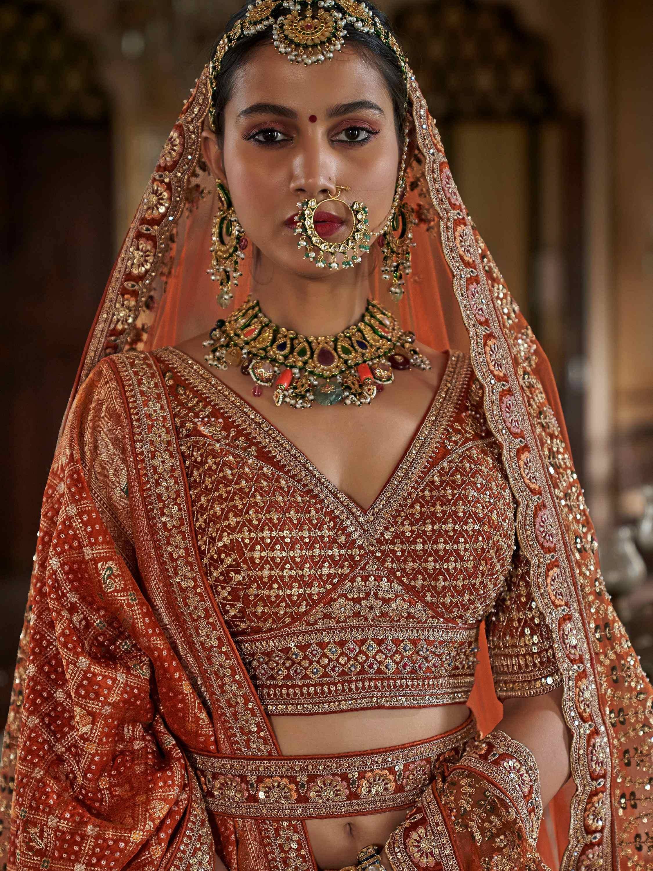 Indian bridal lehenga choli with heavy embroidery, traditional jewelry, and dupatta for wedding wear