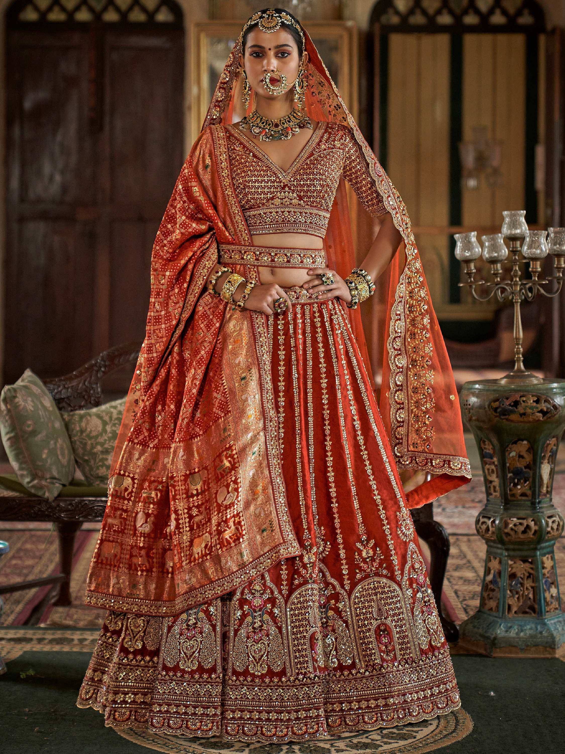 Red and gold embroidered lehenga choli with dupatta, traditional Indian bridal wear