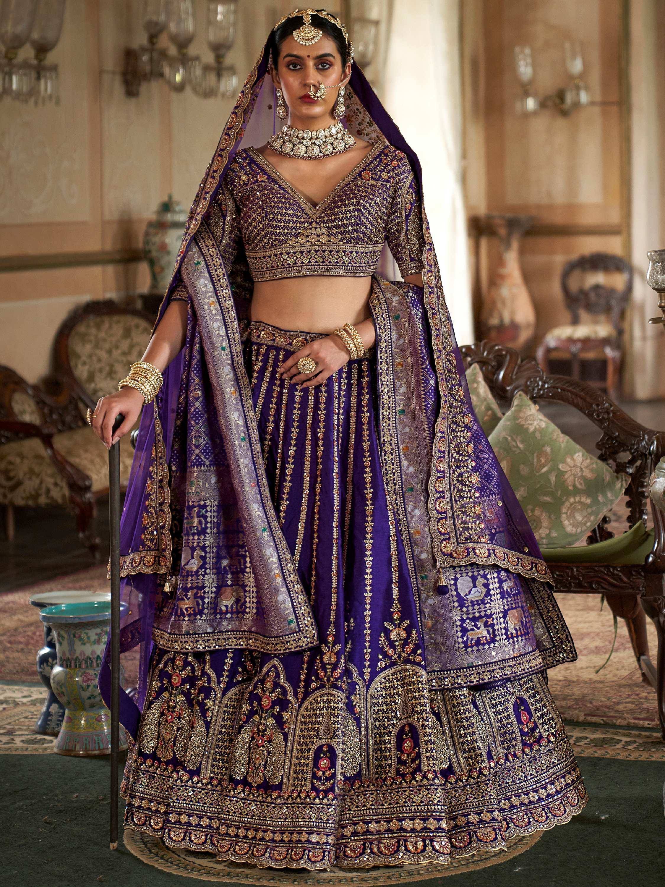 Purple designer lehenga choli with heavy gold embroidery and dupatta, perfect for Indian weddings