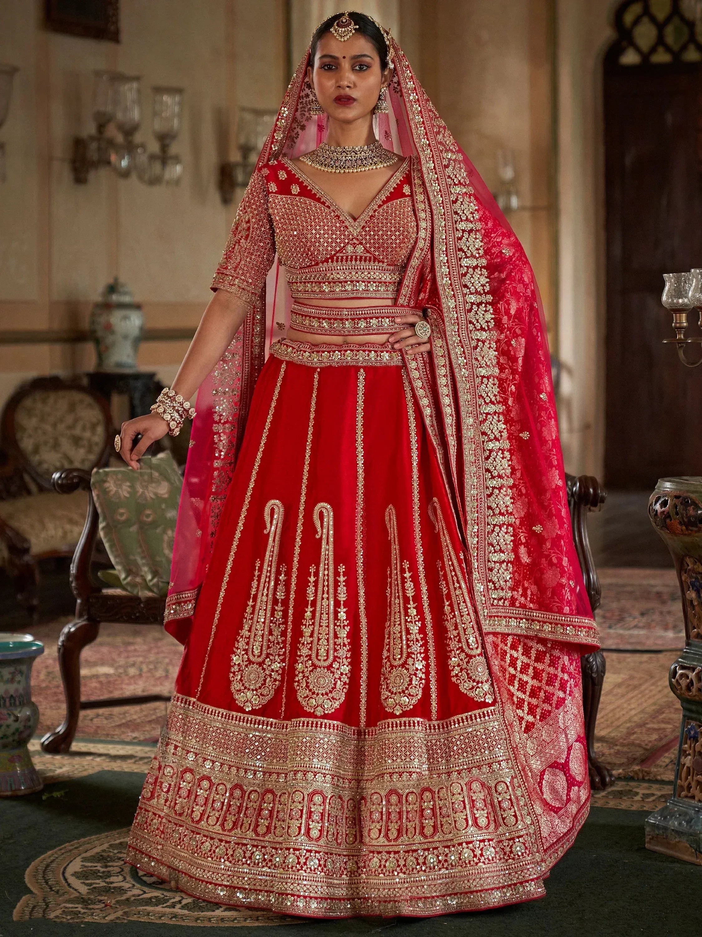 Red bridal lehenga choli with gold embroidery, perfect for Indian weddings and ethnic events.