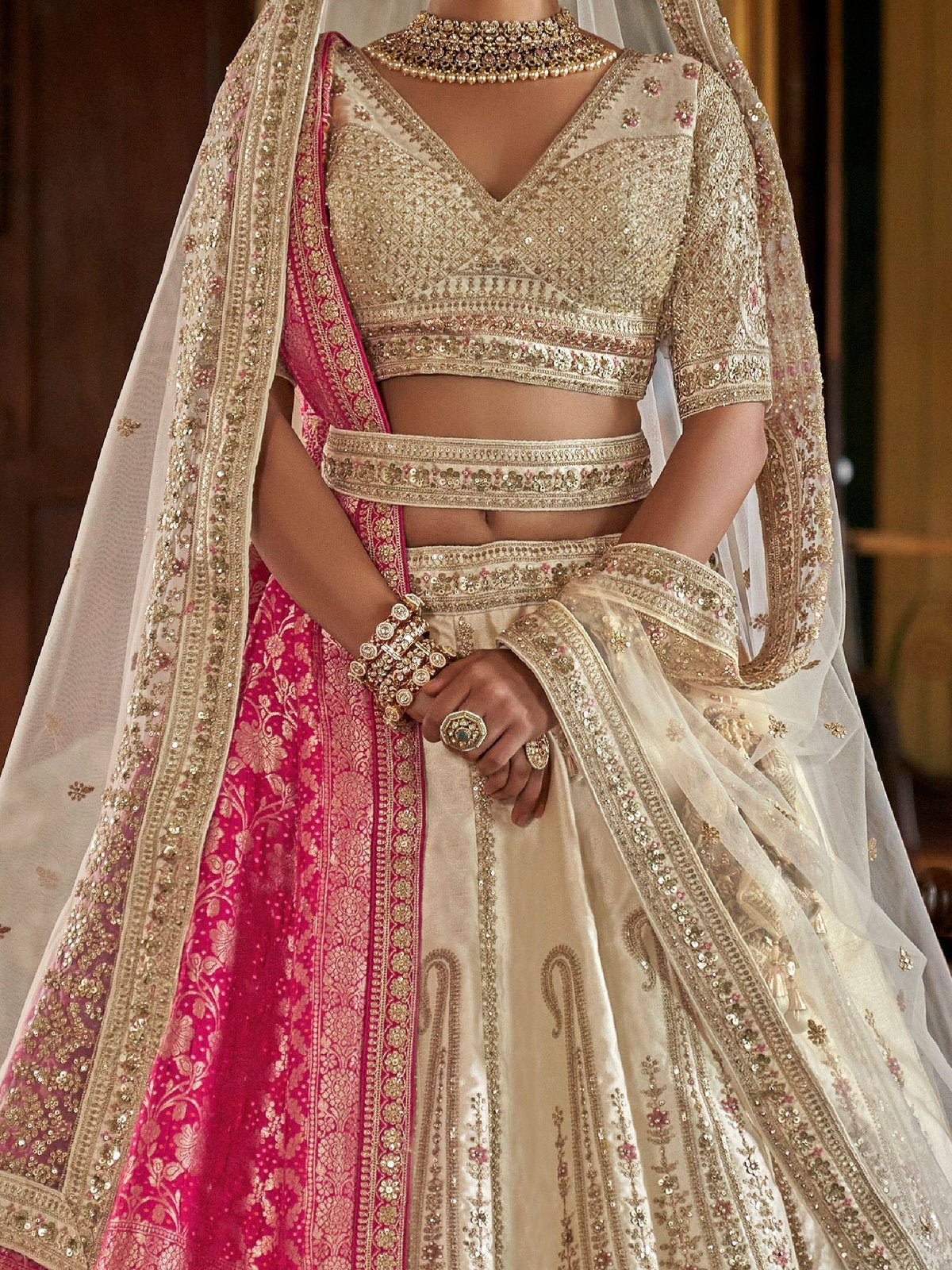 Elegant ivory and pink bridal lehenga choli with heavy gold embroidery and dupatta
