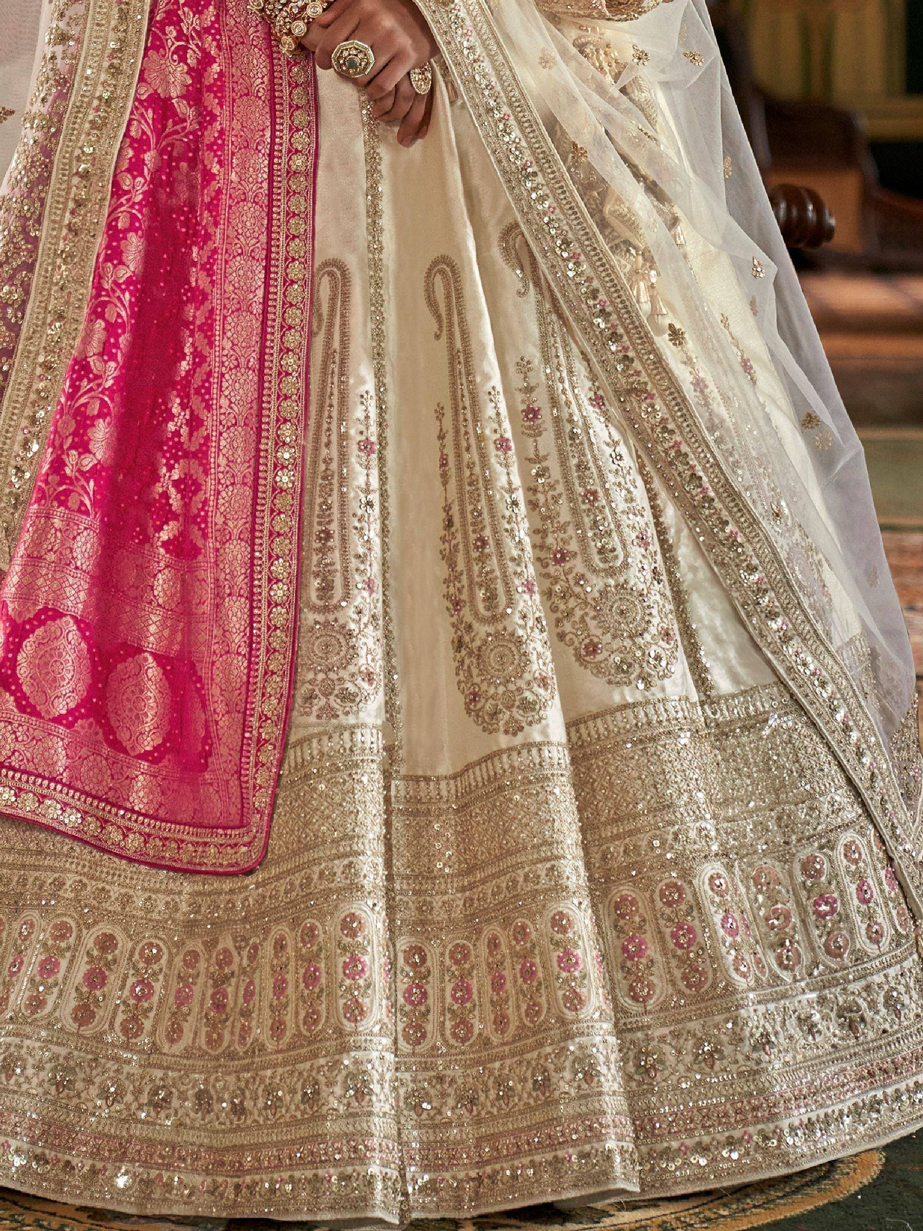 Designer ivory lehenga choli with pink dupatta, heavy embroidery and sequins for Indian weddings