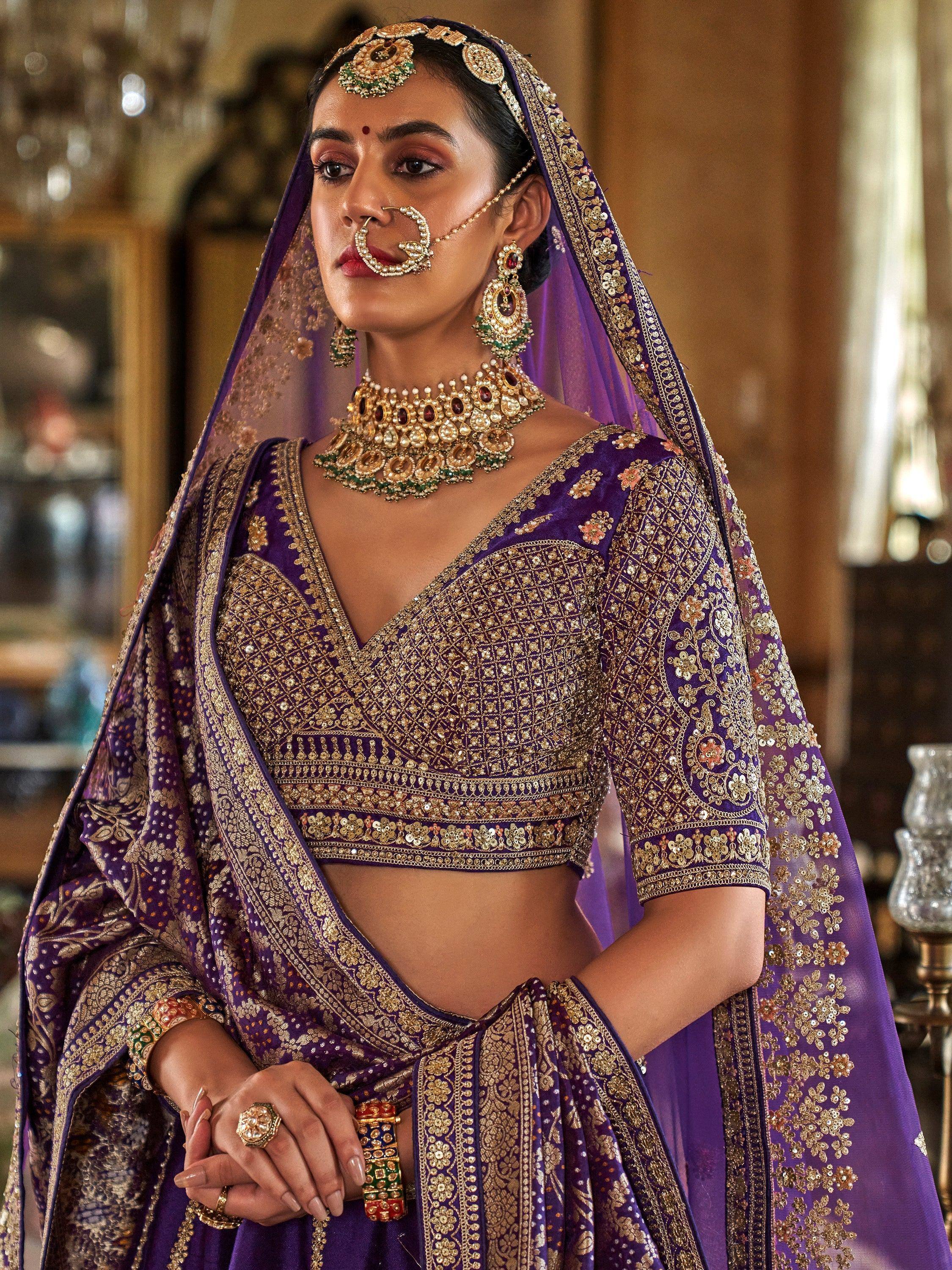 Purple designer lehenga choli with gold embroidery, traditional Indian bridal wear, heavy jewelry