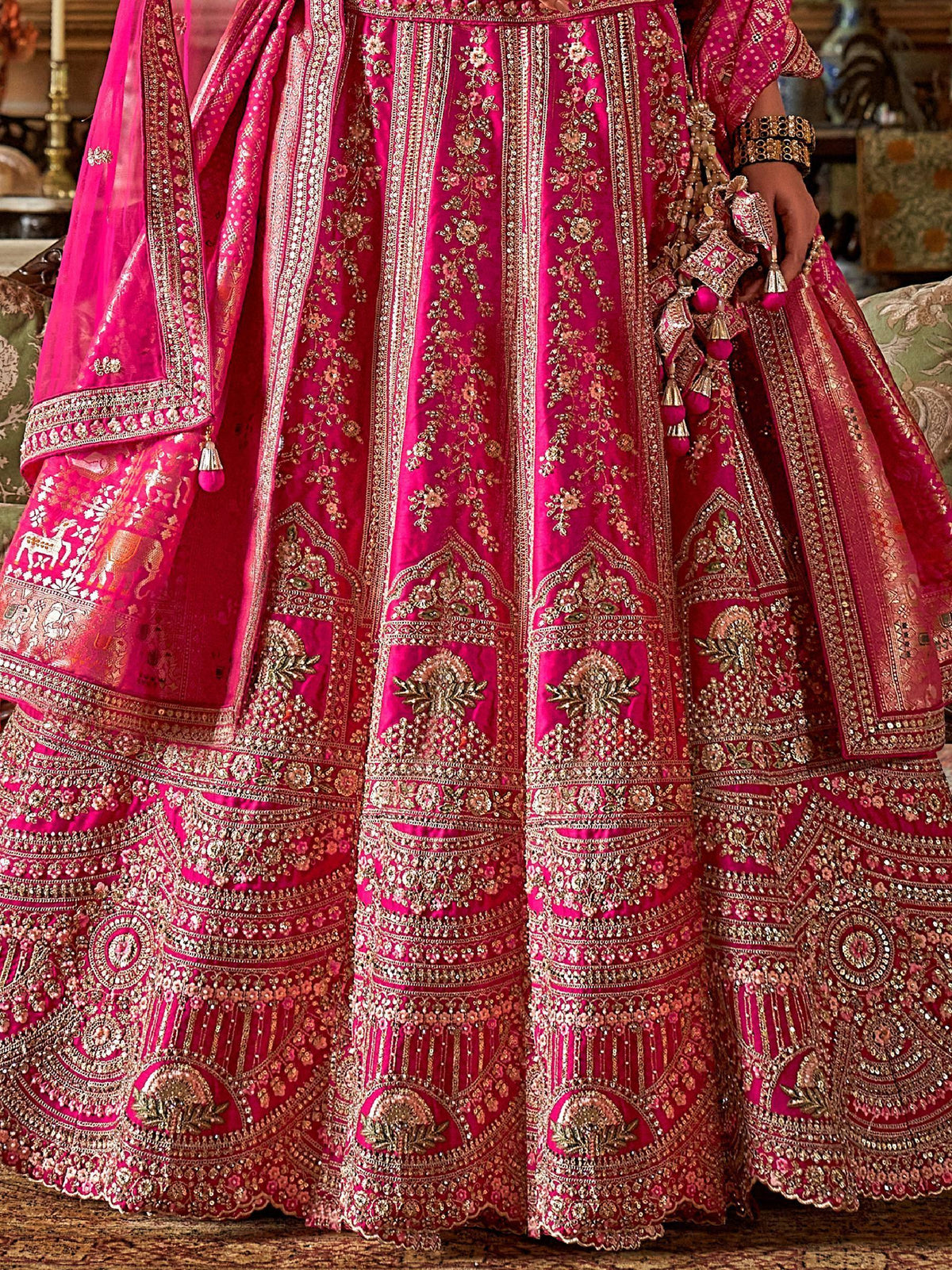 Fuchsia pink designer lehenga choli with heavy gold embroidery and embellished dupatta for Indian weddings