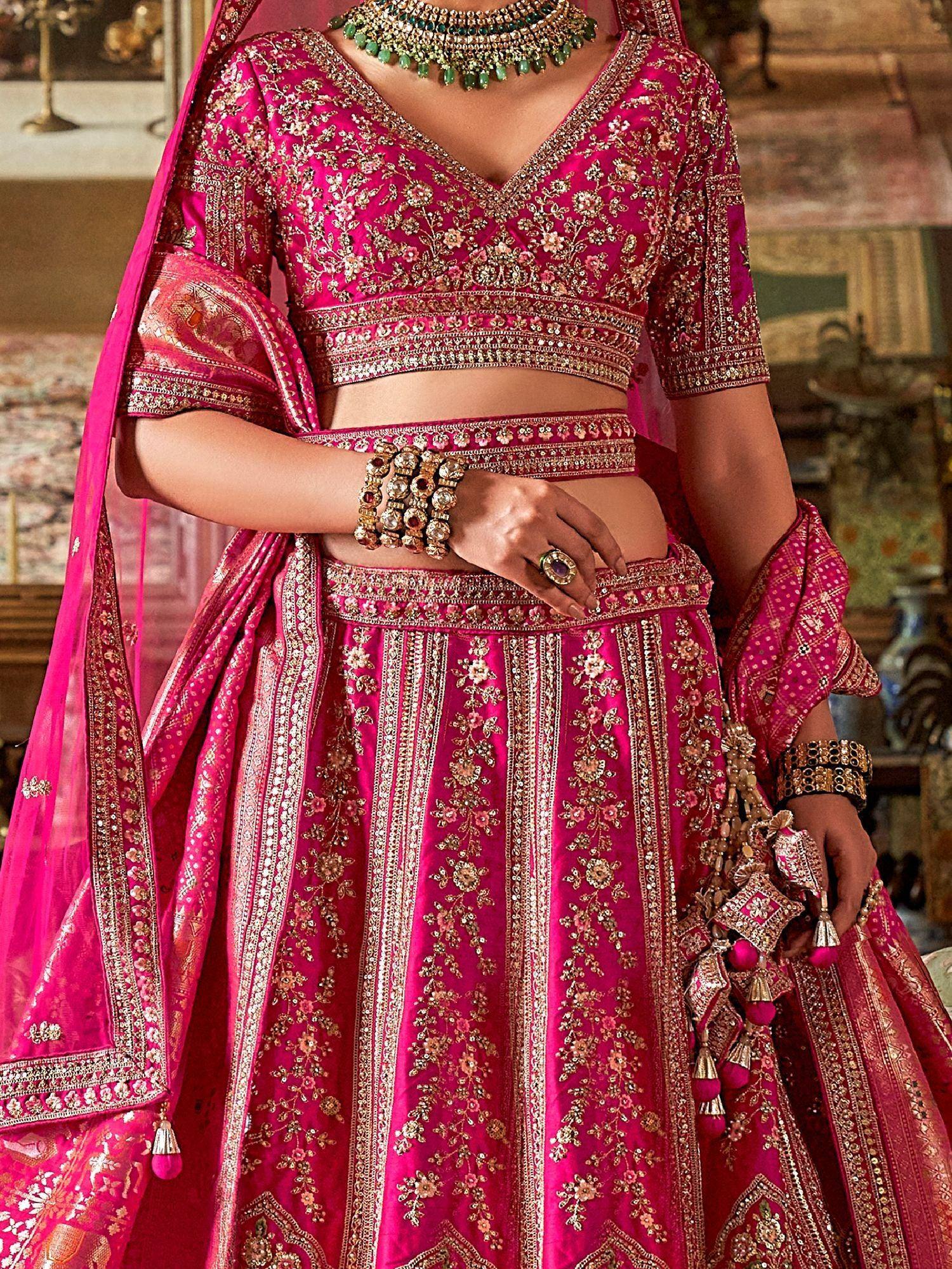 Fuchsia pink designer lehenga choli with gold embroidery, perfect for Indian weddings and festive occasions.