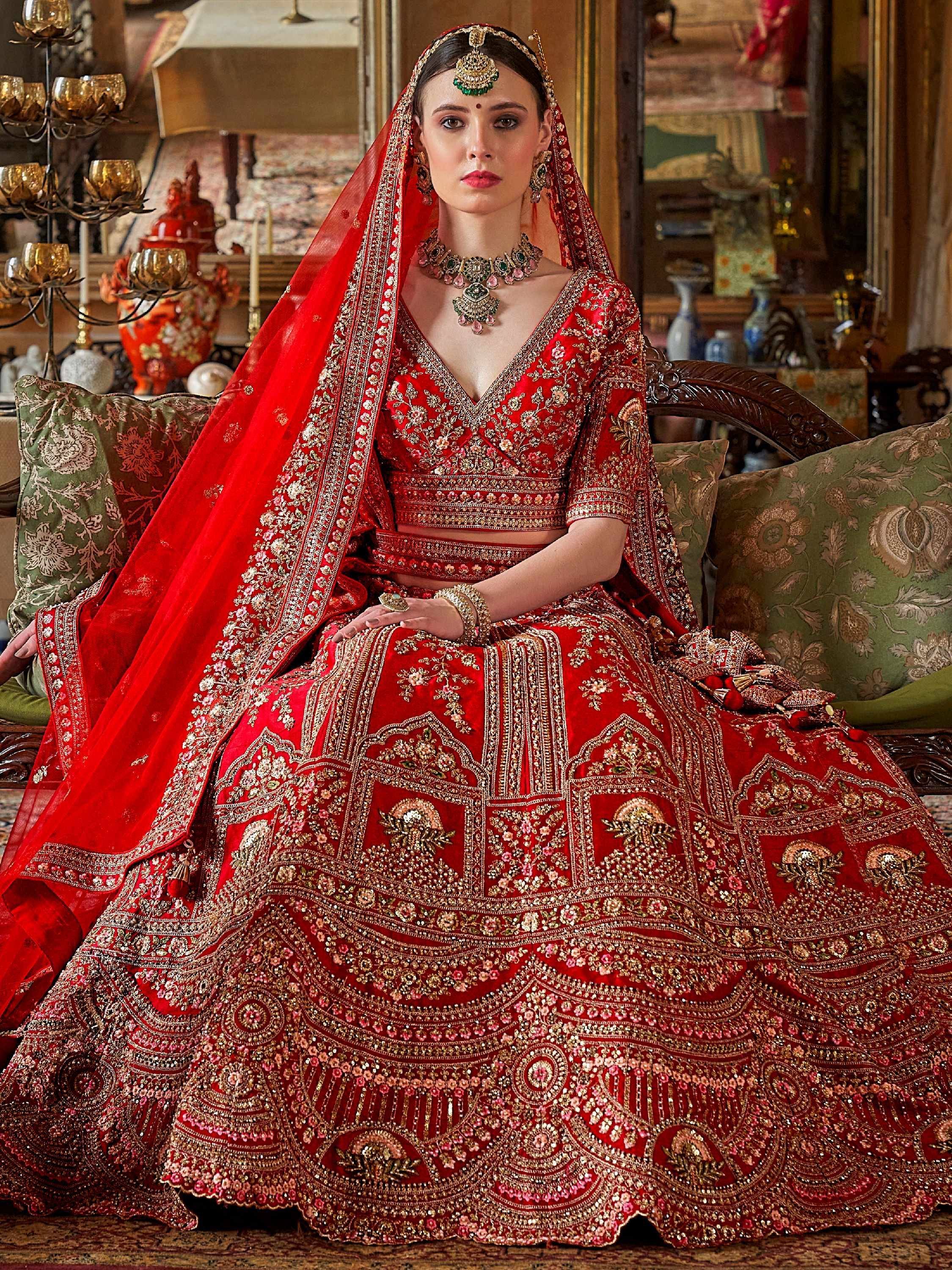 Red bridal lehenga choli with heavy gold embroidery and matching dupatta, perfect for Indian weddings