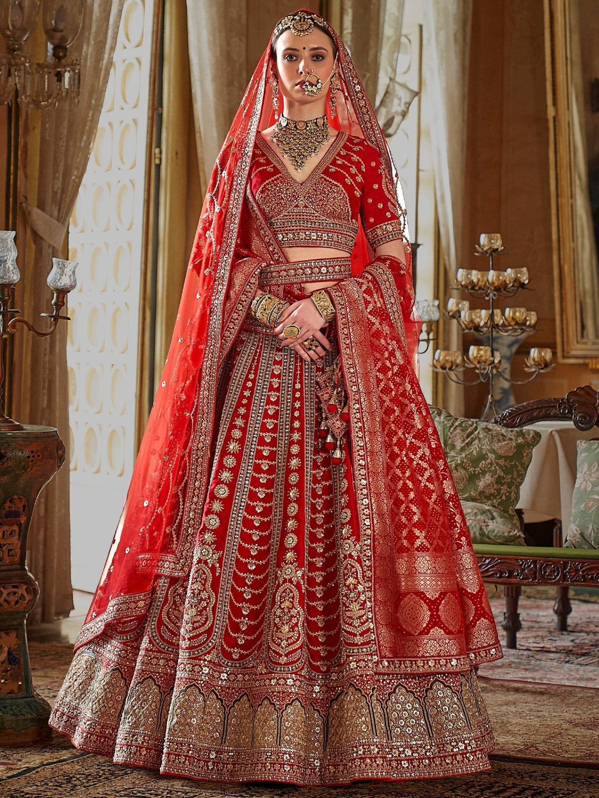 Red bridal lehenga choli with heavy gold embroidery and dupatta, traditional Indian wedding attire