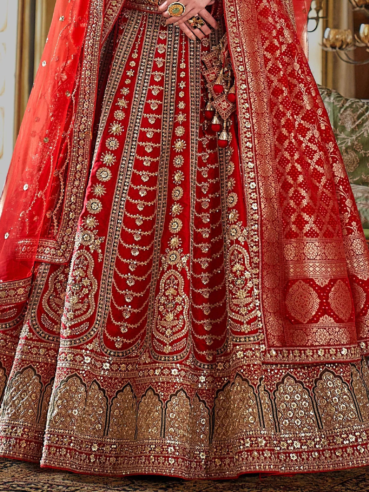 Red bridal lehenga choli with heavy gold embroidery and sequins, perfect for Indian weddings