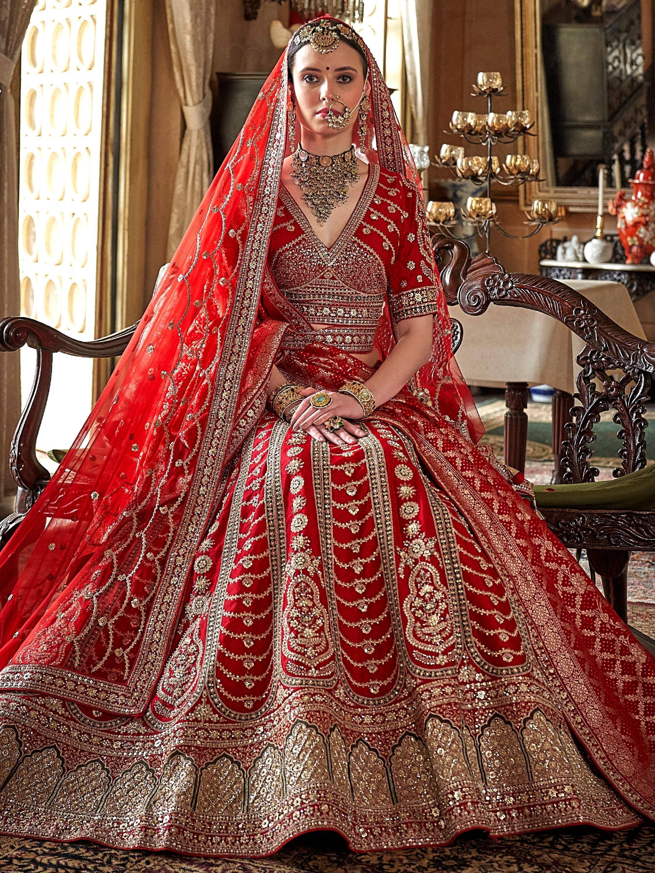 Red bridal lehenga choli with gold embroidery, perfect for Indian weddings and ethnic occasions.