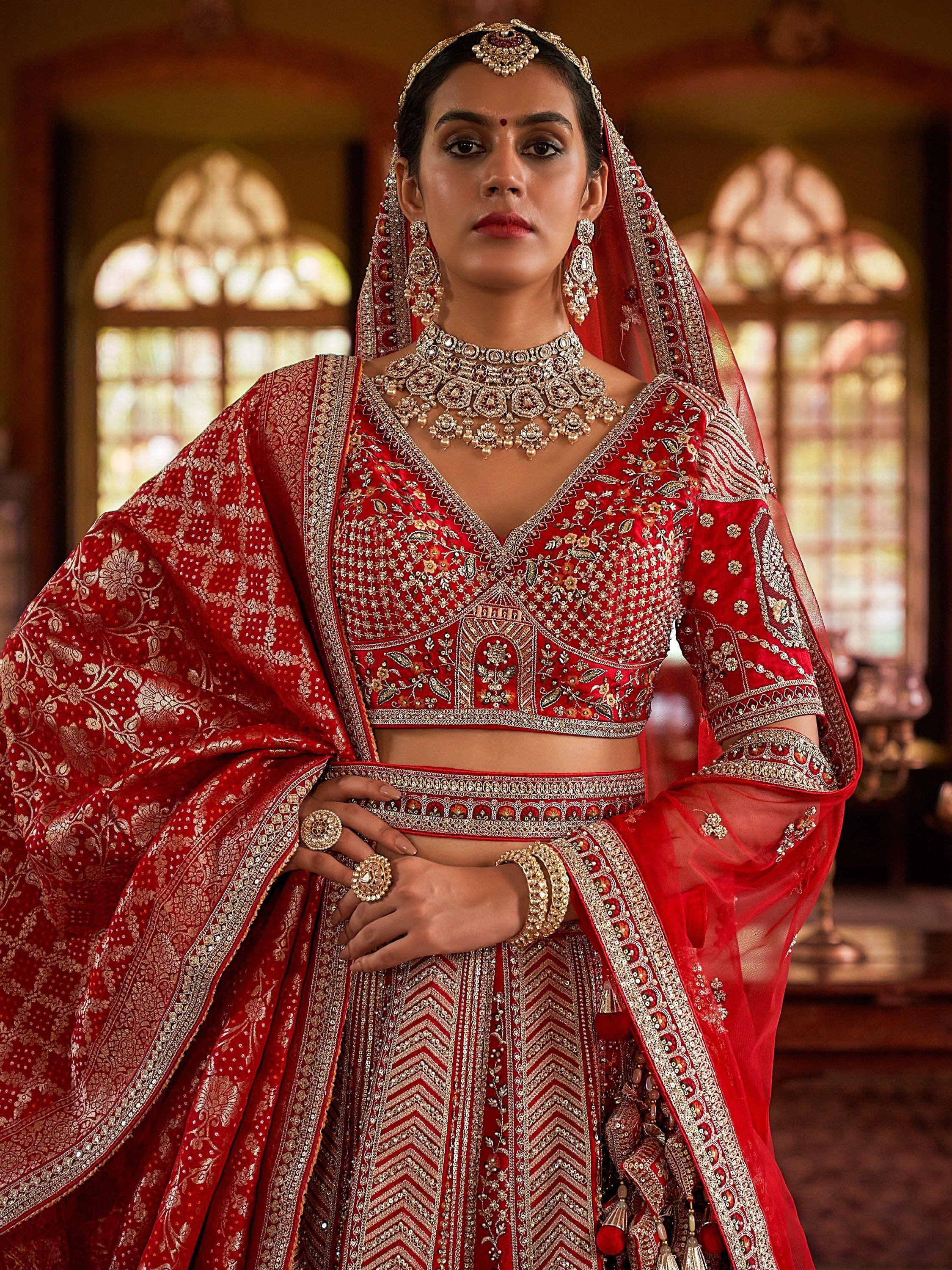Red embroidered lehenga choli with gold detailing, perfect for Indian weddings and festive occasions