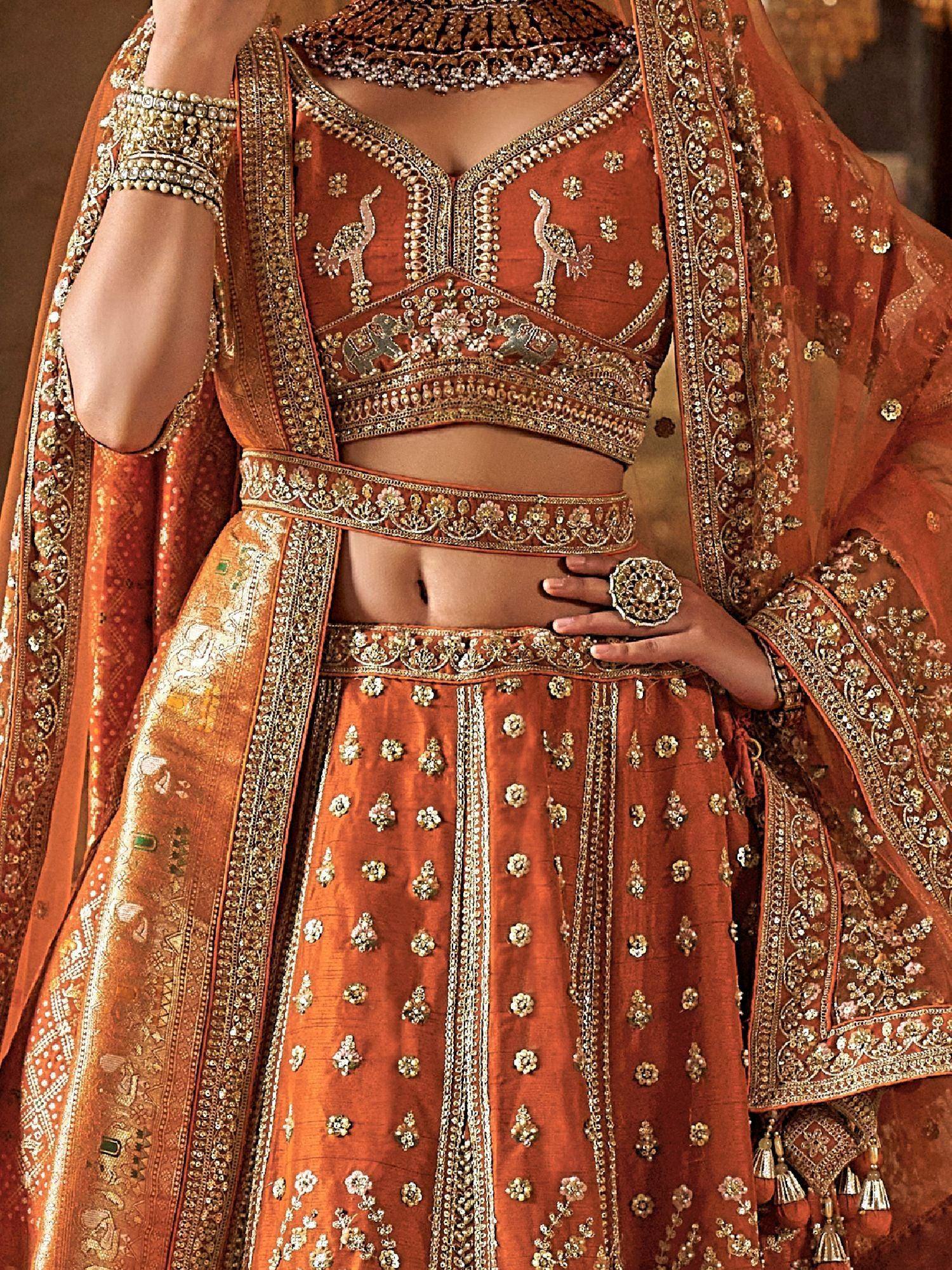 Luxury orange lehenga choli with peacock embroidery, heavy gold work, and matching dupatta for Indian weddings