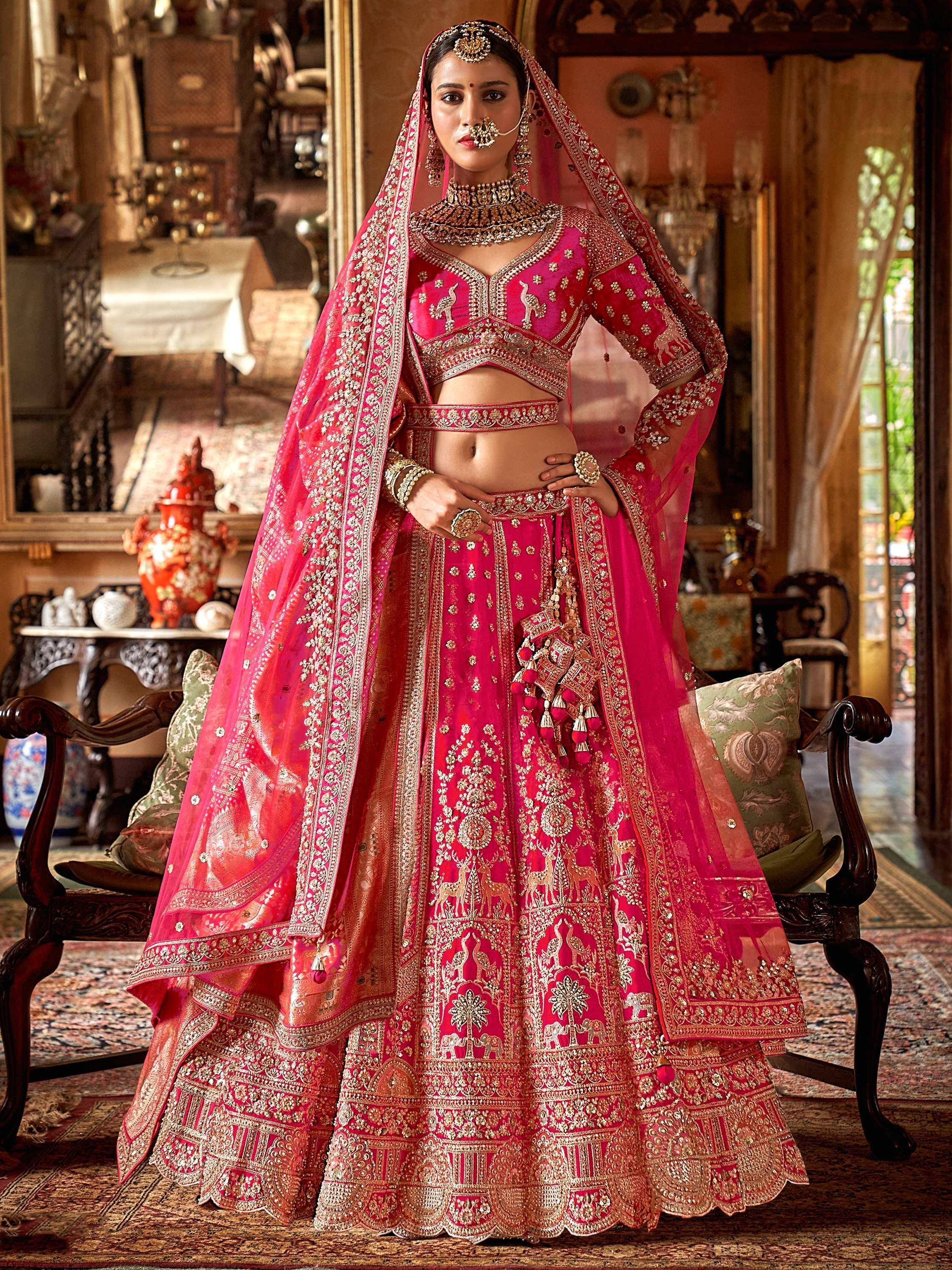 Pink embroidered lehenga choli with gold detailing, perfect for Indian weddings and festive occasions