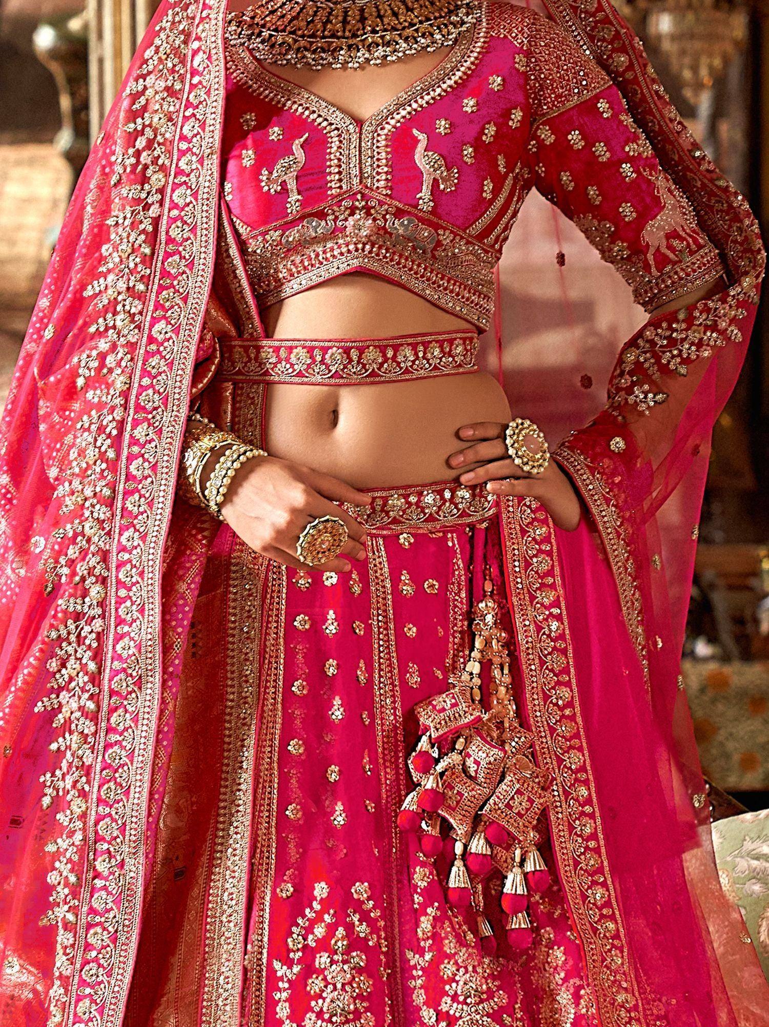 Pink embroidered lehenga choli with peacock motifs and gold detailing, perfect for Indian weddings