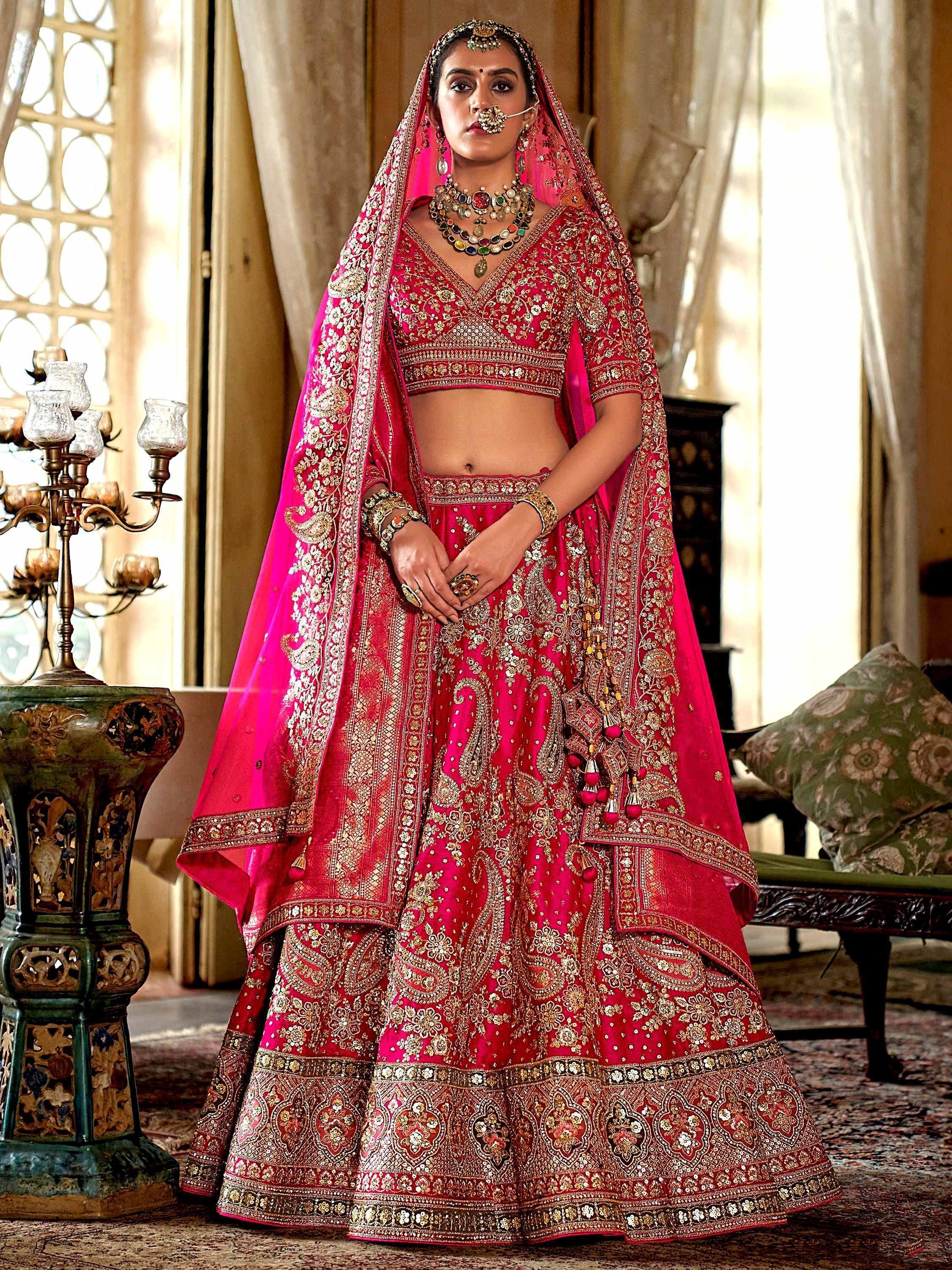 Pink embroidered lehenga choli with gold detailing, traditional Indian bridal wear