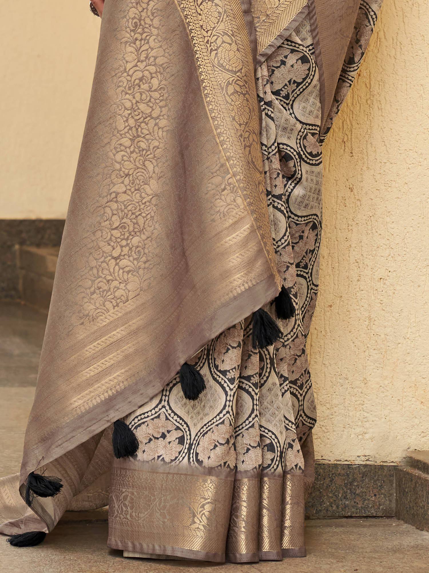 Elegant beige and black printed saree with tassels, perfect for Indian ethnic wear occasions