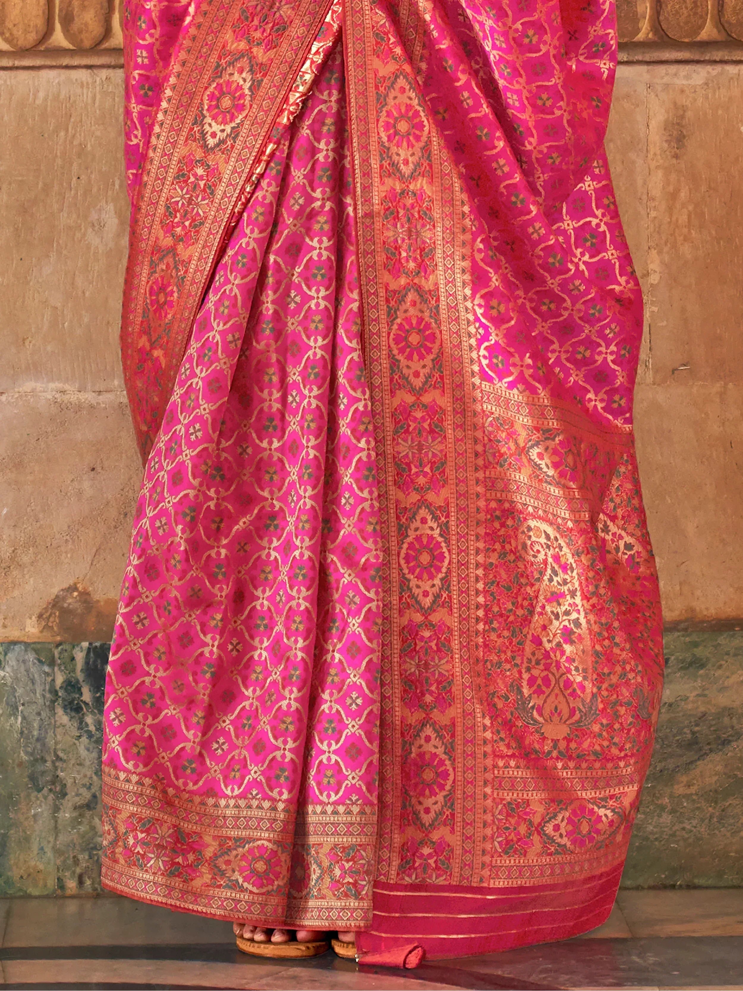 Vibrant pink and gold designer saree with intricate floral and geometric patterns, perfect for ethnic occasions.