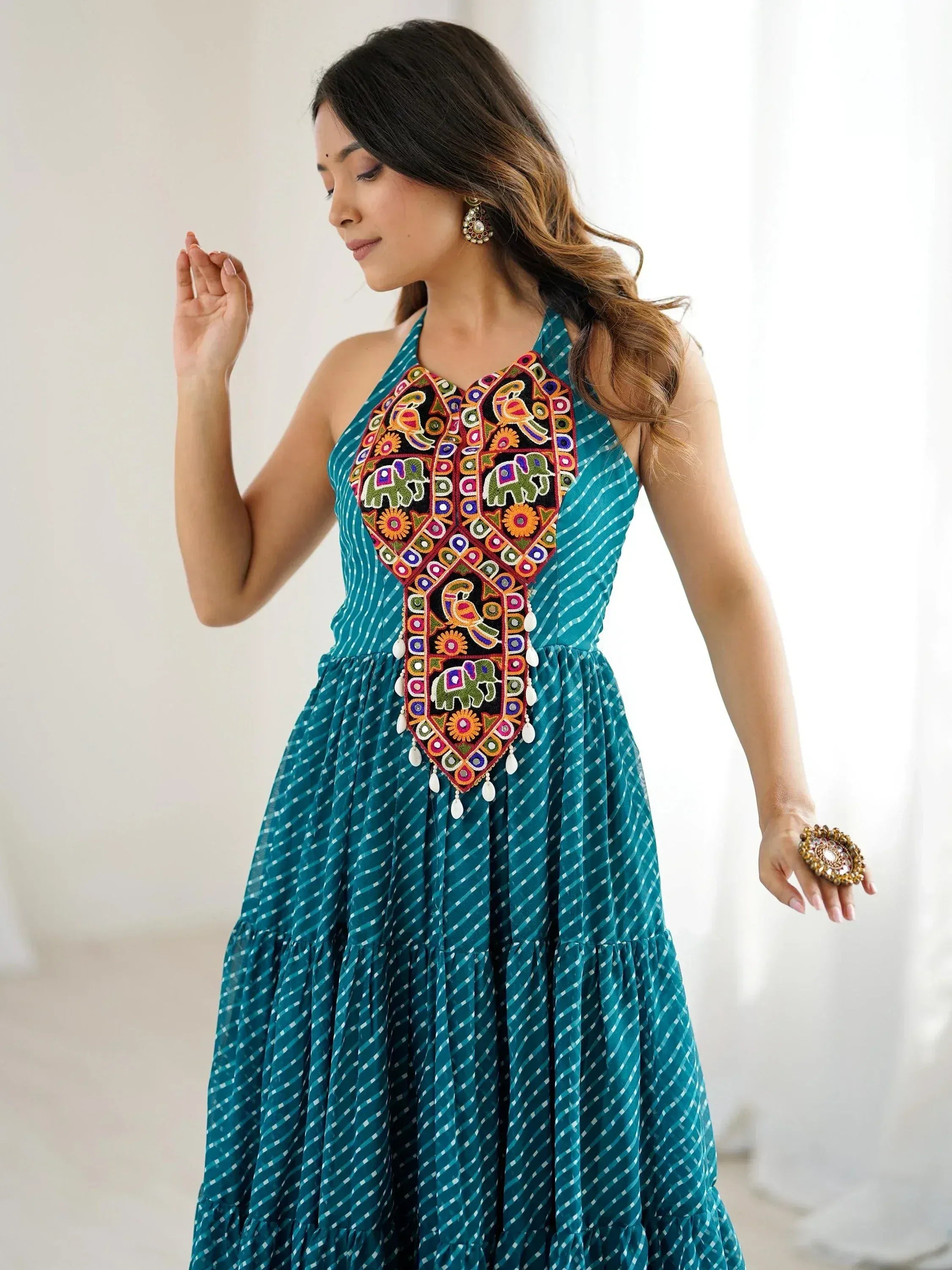 Teal ethnic gown with colorful elephant and bird embroidery, perfect for Indian festive occasions.