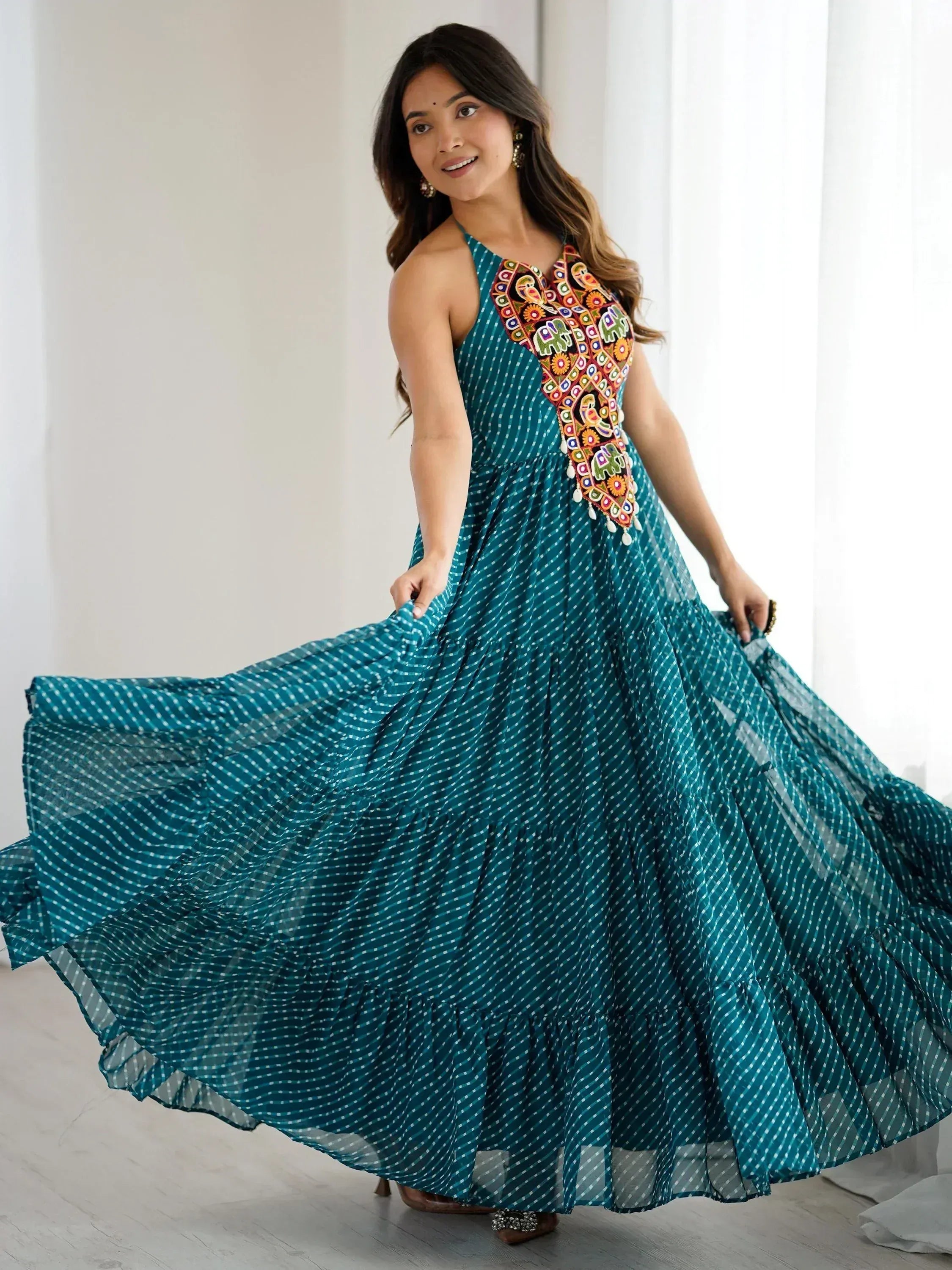 Teal ethnic gown with colorful embroidery and polka dots, perfect for festive occasions