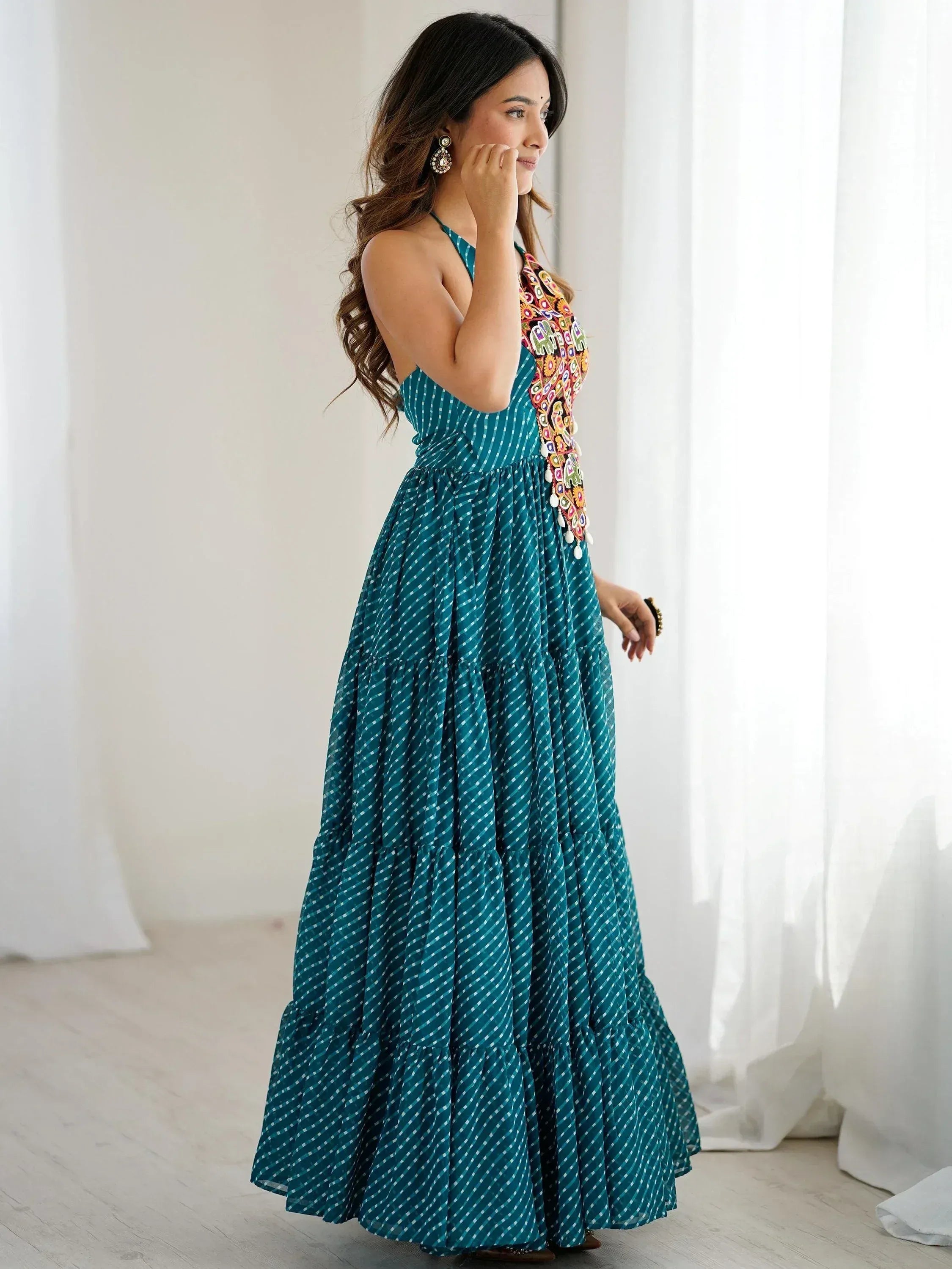 Teal ethnic gown with colorful embroidery and tiered skirt, perfect for festive occasions
