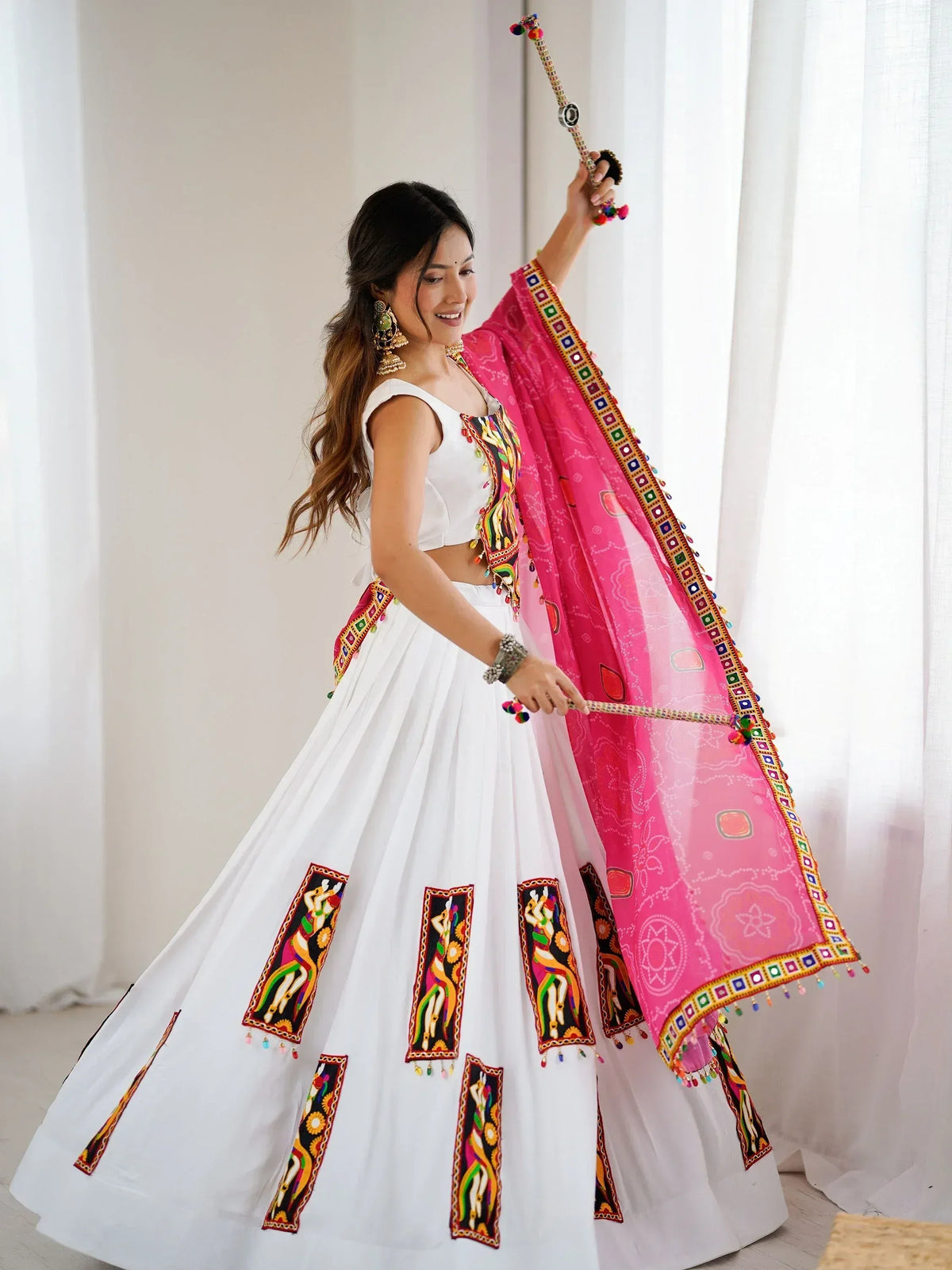 White embroidered lehenga with pink dupatta and traditional accessories