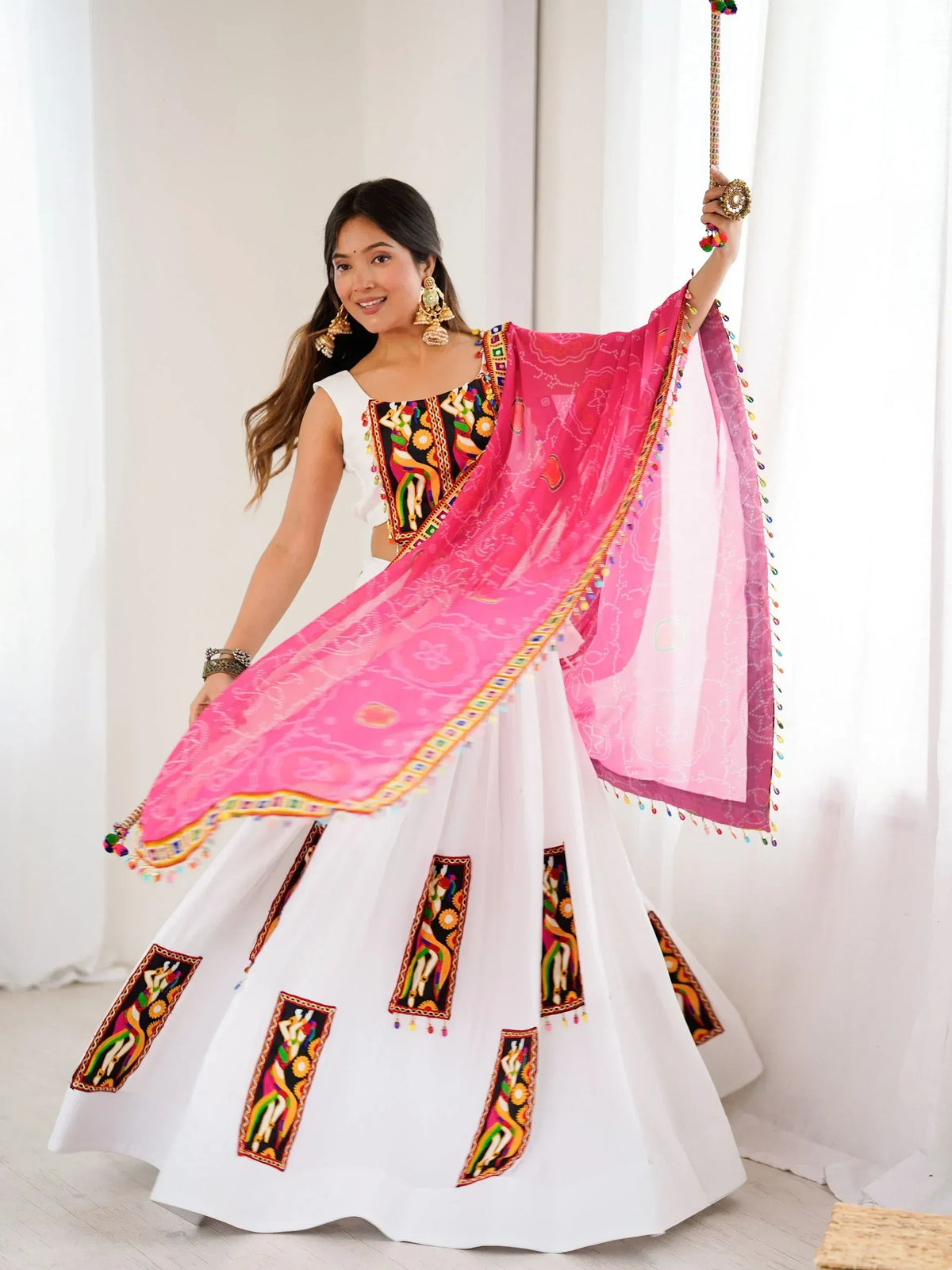 White lehenga choli with colorful embroidery and pink dupatta, perfect for Indian ethnic wear