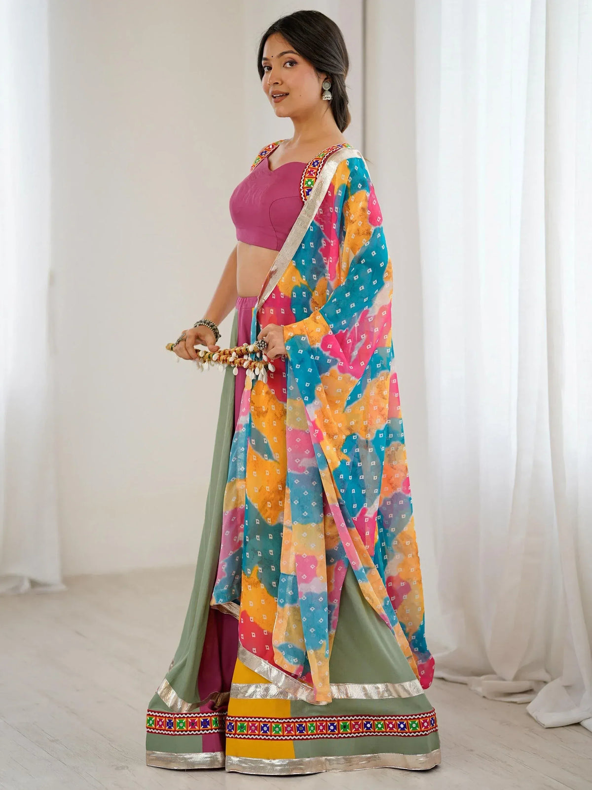 Colorful Indian lehenga choli with tie-dye dupatta, perfect for festive occasions and ethnic wear.