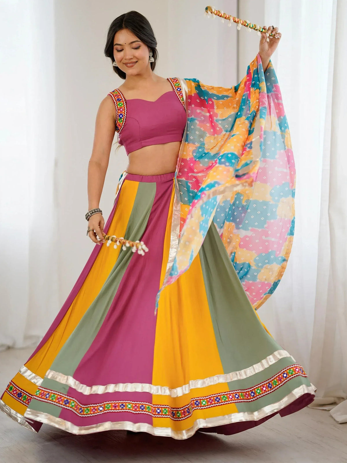 Colorful Indian lehenga choli with embroidered blouse, striped skirt, and printed dupatta for festive wear