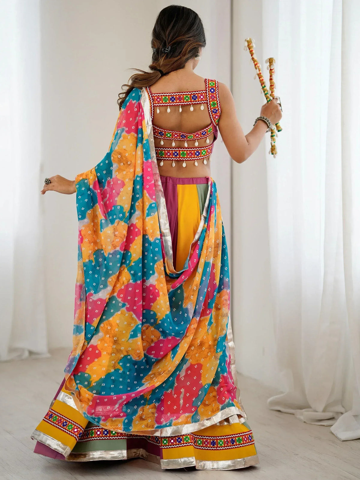 Colorful Indian ethnic wear with mirror work blouse and printed dupatta, perfect for festive occasions