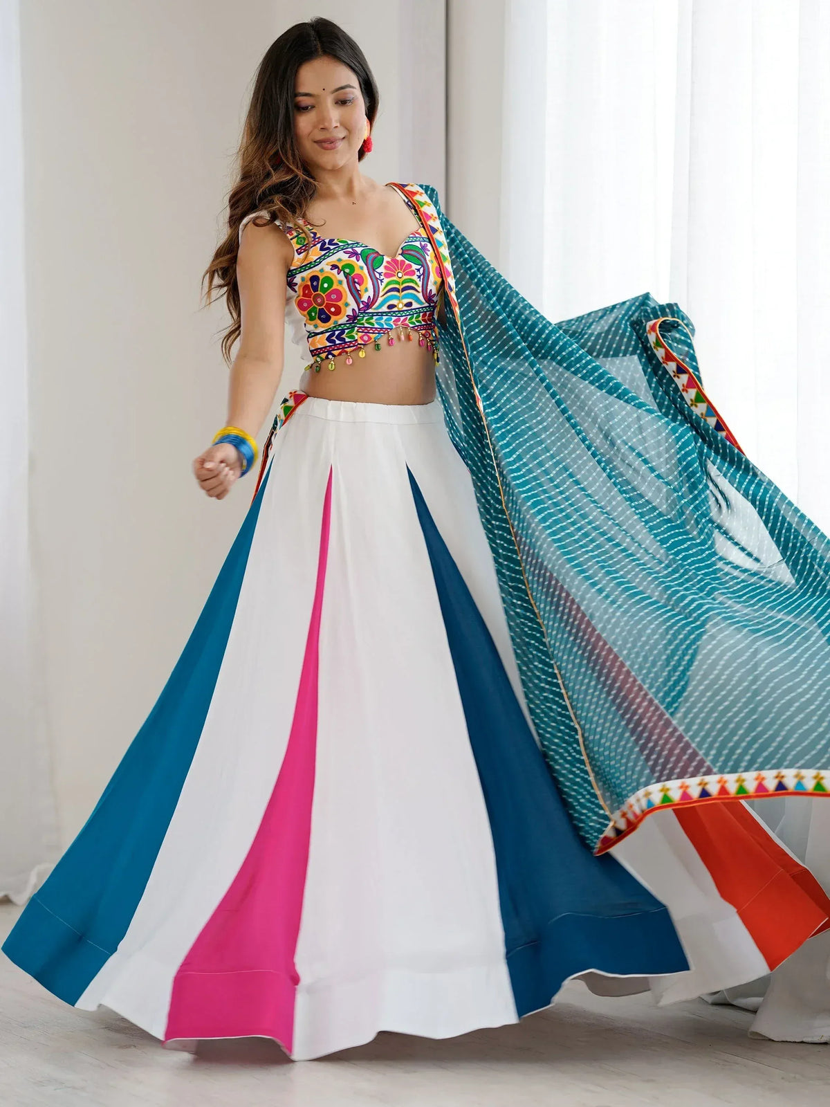 Colorful embroidered lehenga choli with white skirt, blue pink panels, and sheer dupatta for Indian ethnic wear