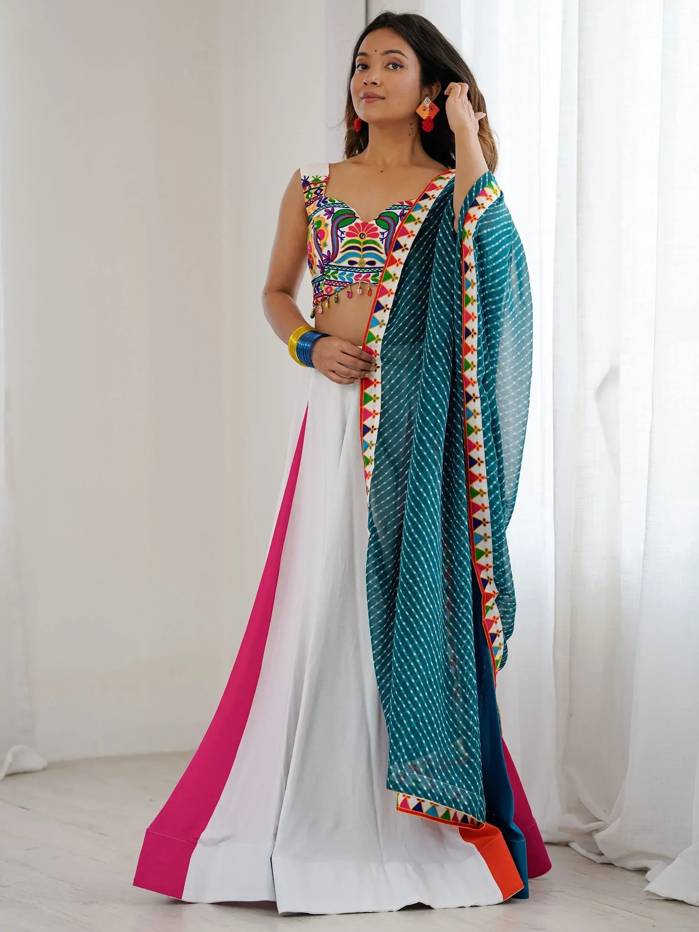 Woman in colorful embroidered lehenga choli with teal dupatta, Indian ethnic wear