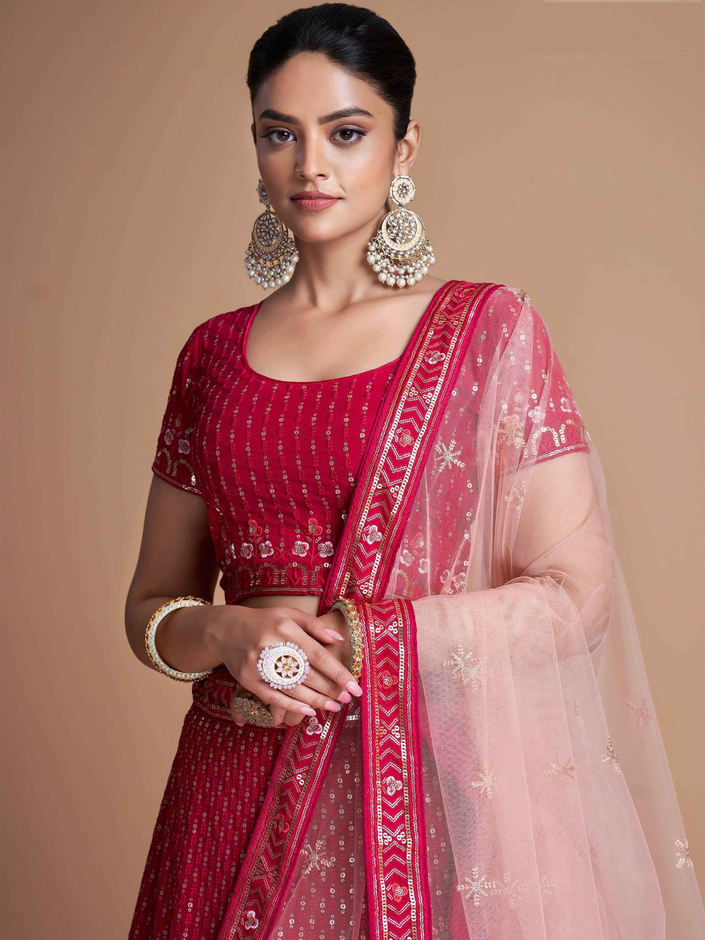 Elegant red embroidered lehenga choli with sheer dupatta, perfect for Indian ethnic wear