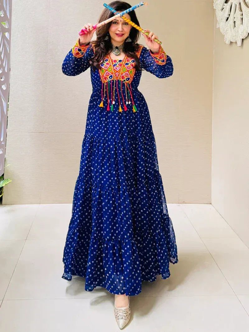 Blue ethnic gown with colorful embroidery and tassels, paired with silver heels for festive occasions