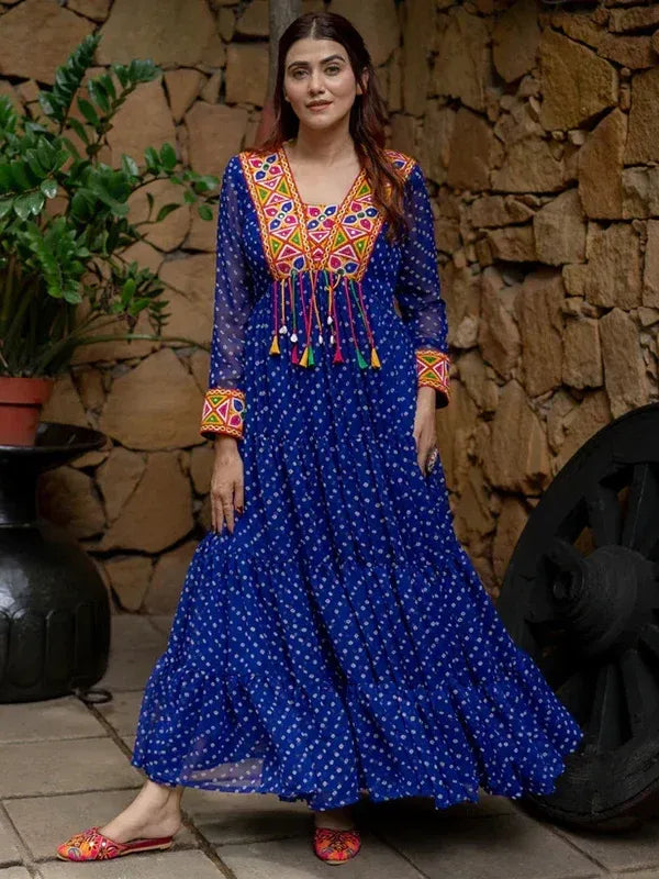 Blue ethnic gown with colorful embroidery and tassels, paired with matching footwear