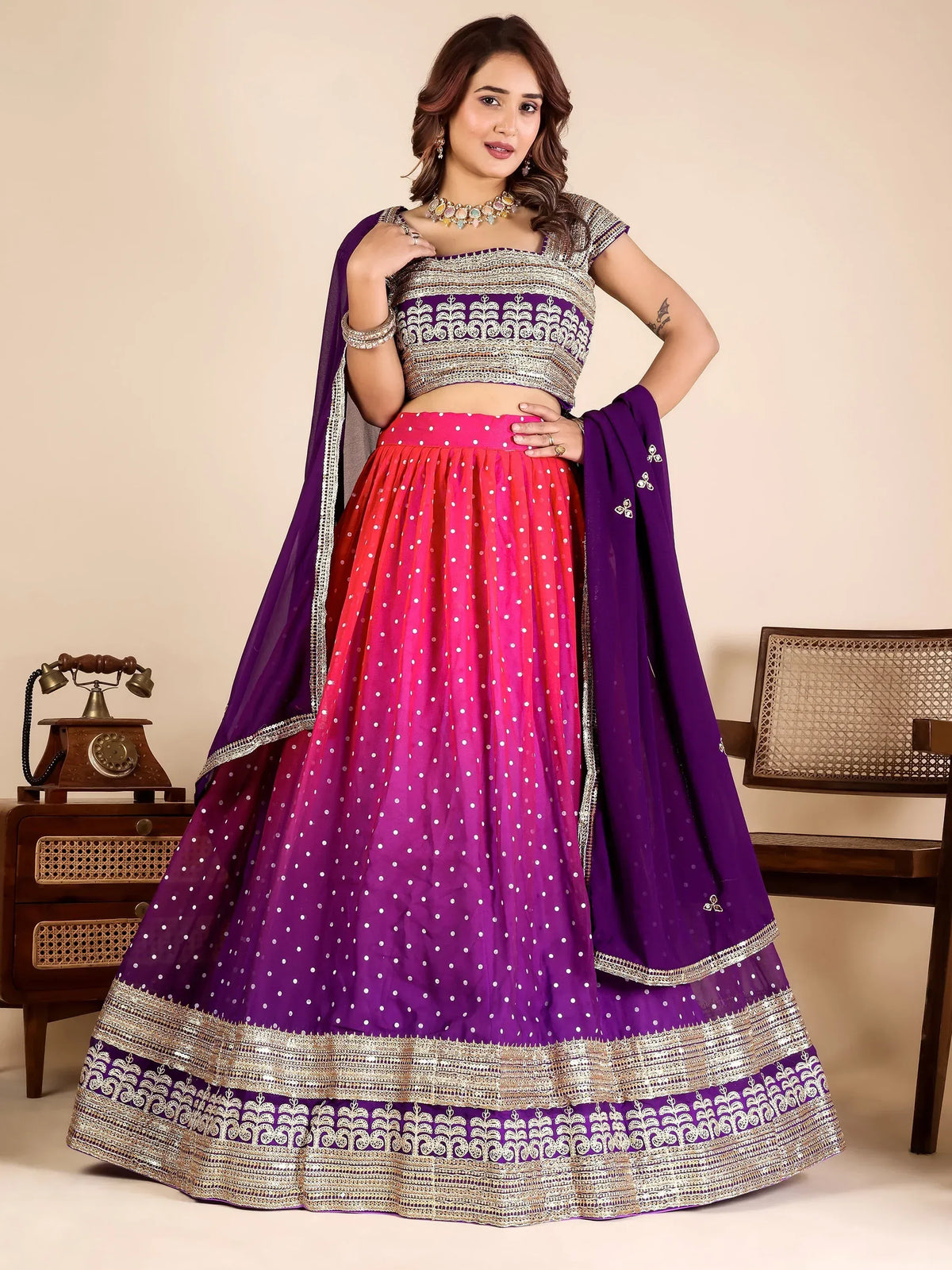 Woman wearing a purple and pink ombre designer lehenga choli with silver embroidery.