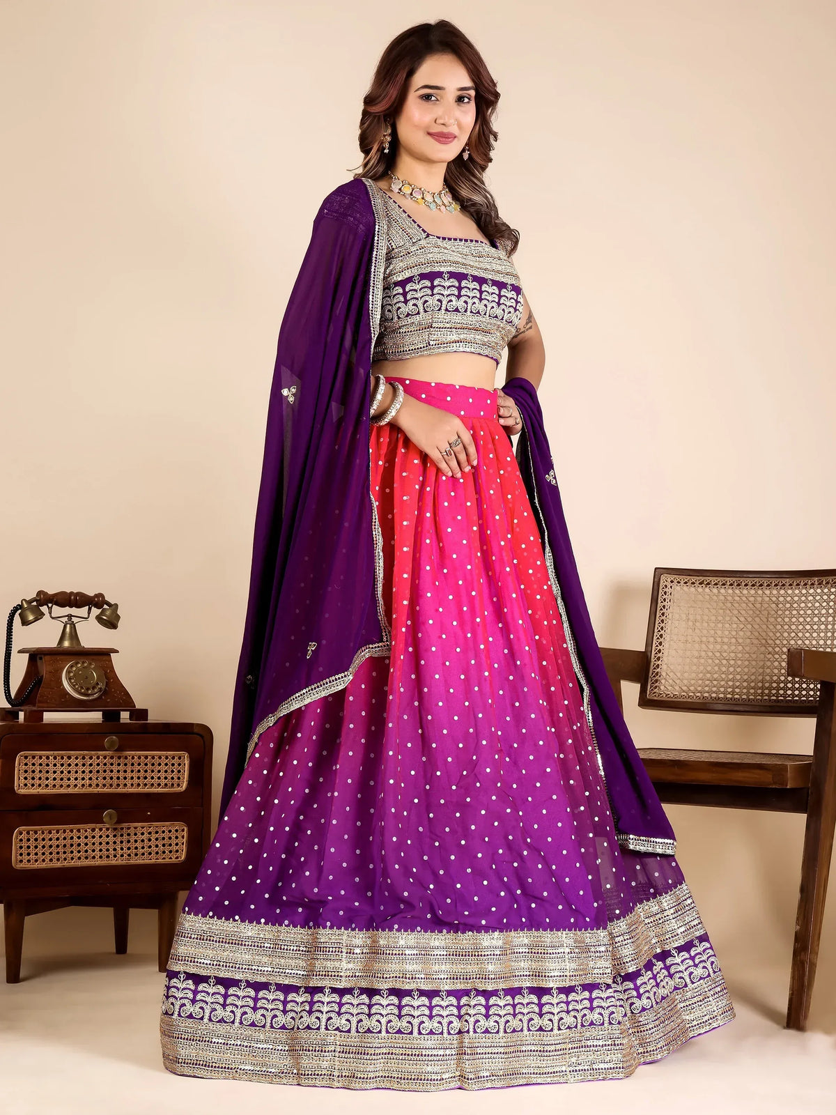 Woman in a purple and pink ombre designer lehenga choli with silver embroidery